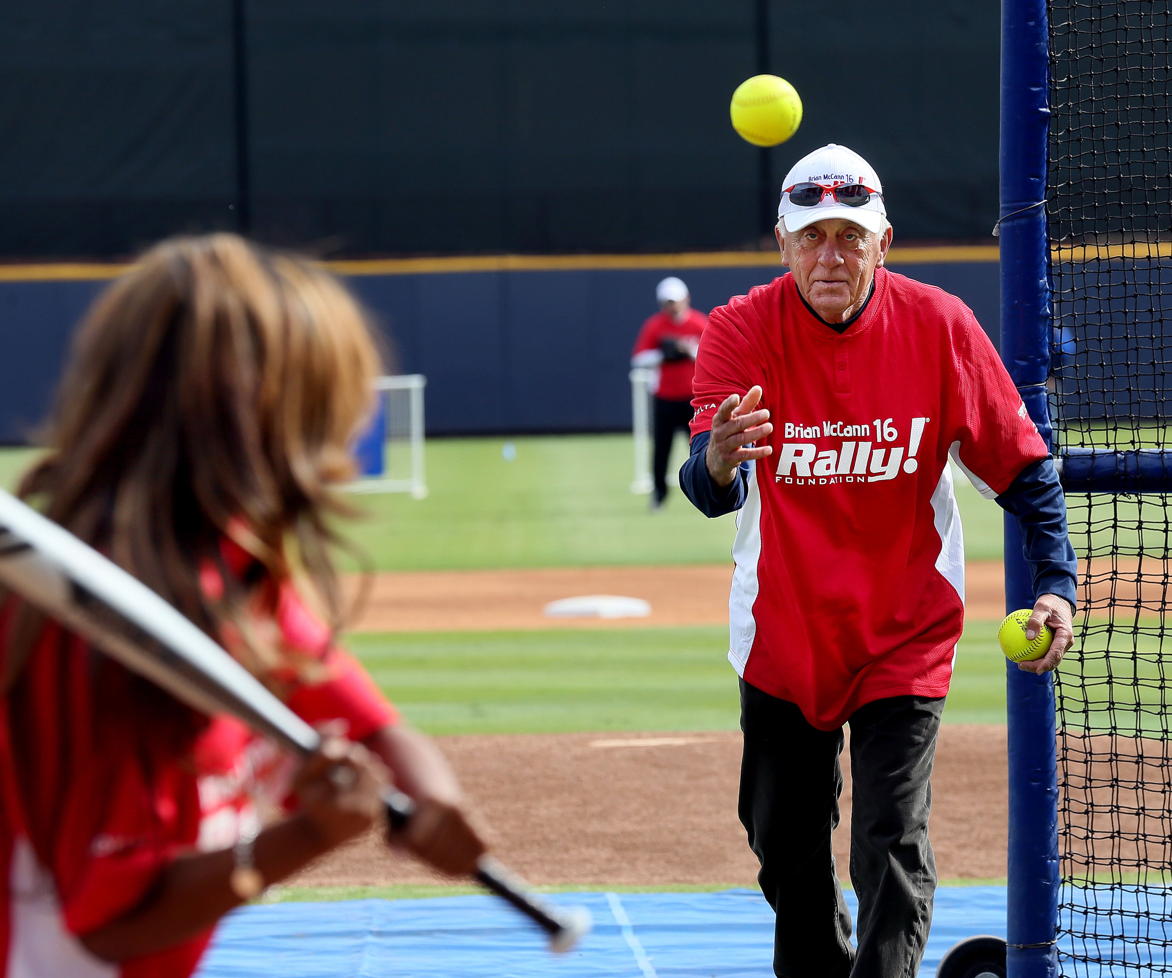 Hall of famer Phil Niekro (right) pitches during the Home Run Challenge, part of the 5th annualBrian McCann Rally Foundation Celebrity Softball Game at Coolray field in Lawrenceville on Saturday November 9th, 2013. Bert's Big Bats team played against Tug's Triple Threat in the event that raised funds for childhood cancer research.