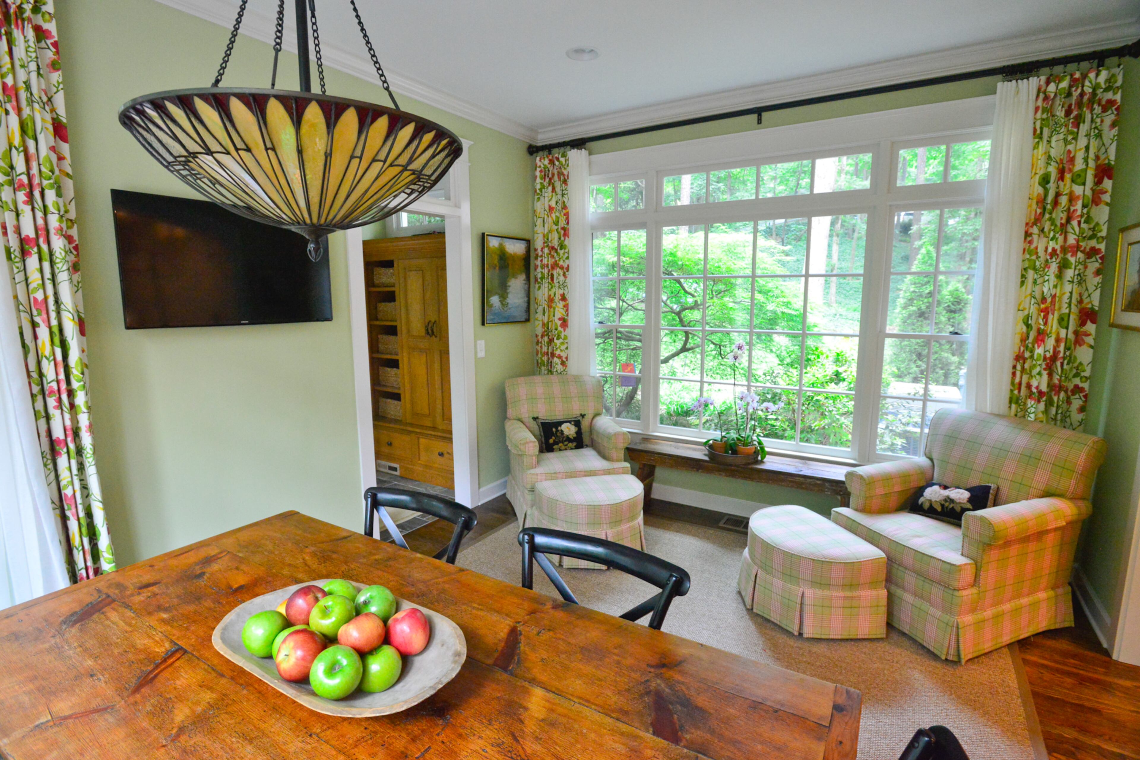 In the new Buckhead breakfast room, special pieces include the Tiffany lamp, which was a housewarming gift from family, and the kitchen table, made by Samuel Stolzfus of Lancaster, Penn. The chairs were purchased from Scotts Antique Markets and recovered in fabric that's coordinated with the walls painted Sherwin-Williams' Shagreen. Holly Builders and Remodelers, based in Marietta, added the breakfast room.