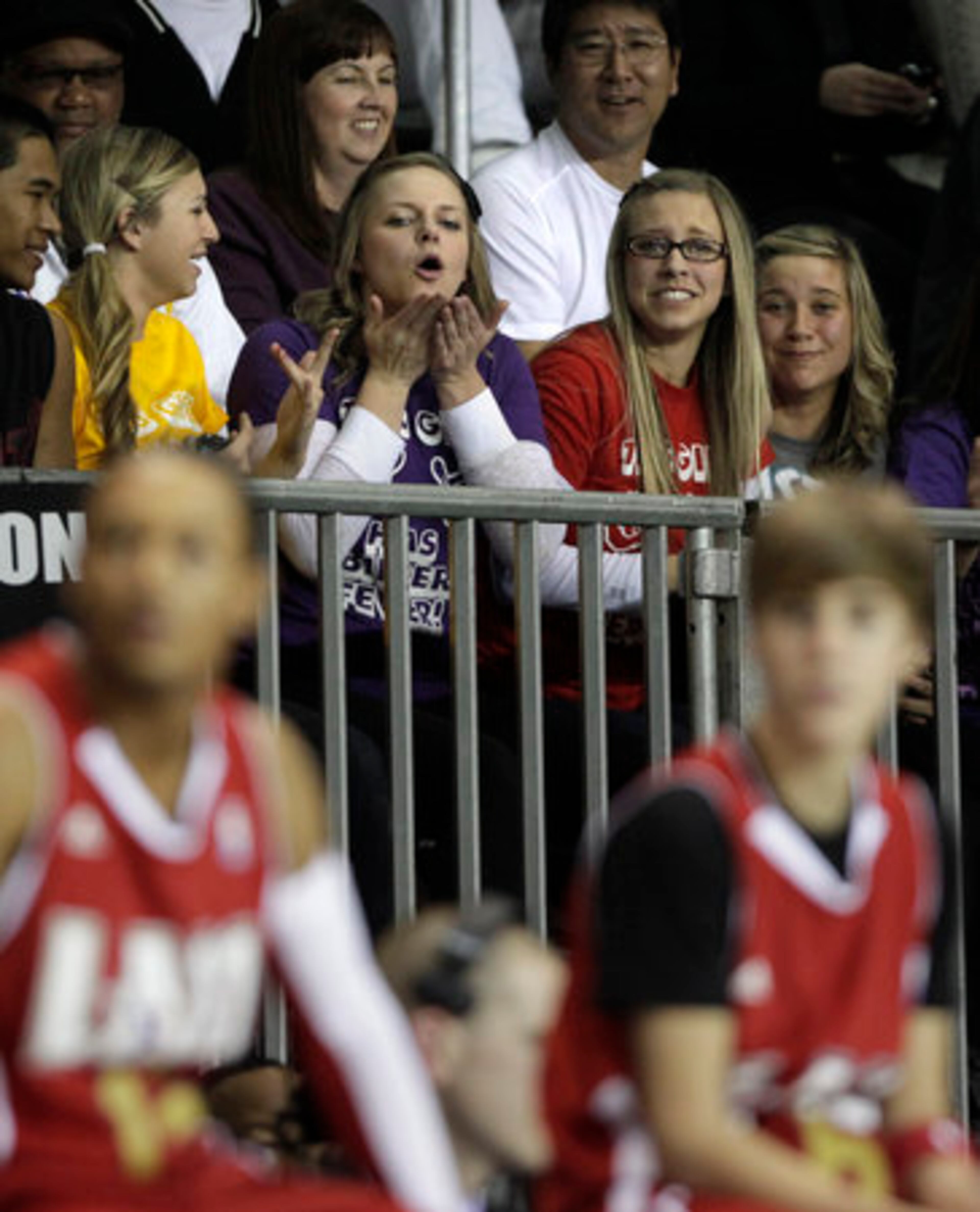 A fan blows a kiss to Justin Bieber, foreground right, while watching a BBVA All-Star celebrity basketball game at the NBA All Star Weekend in Los Angeles, Friday, Feb. 18, 2011.