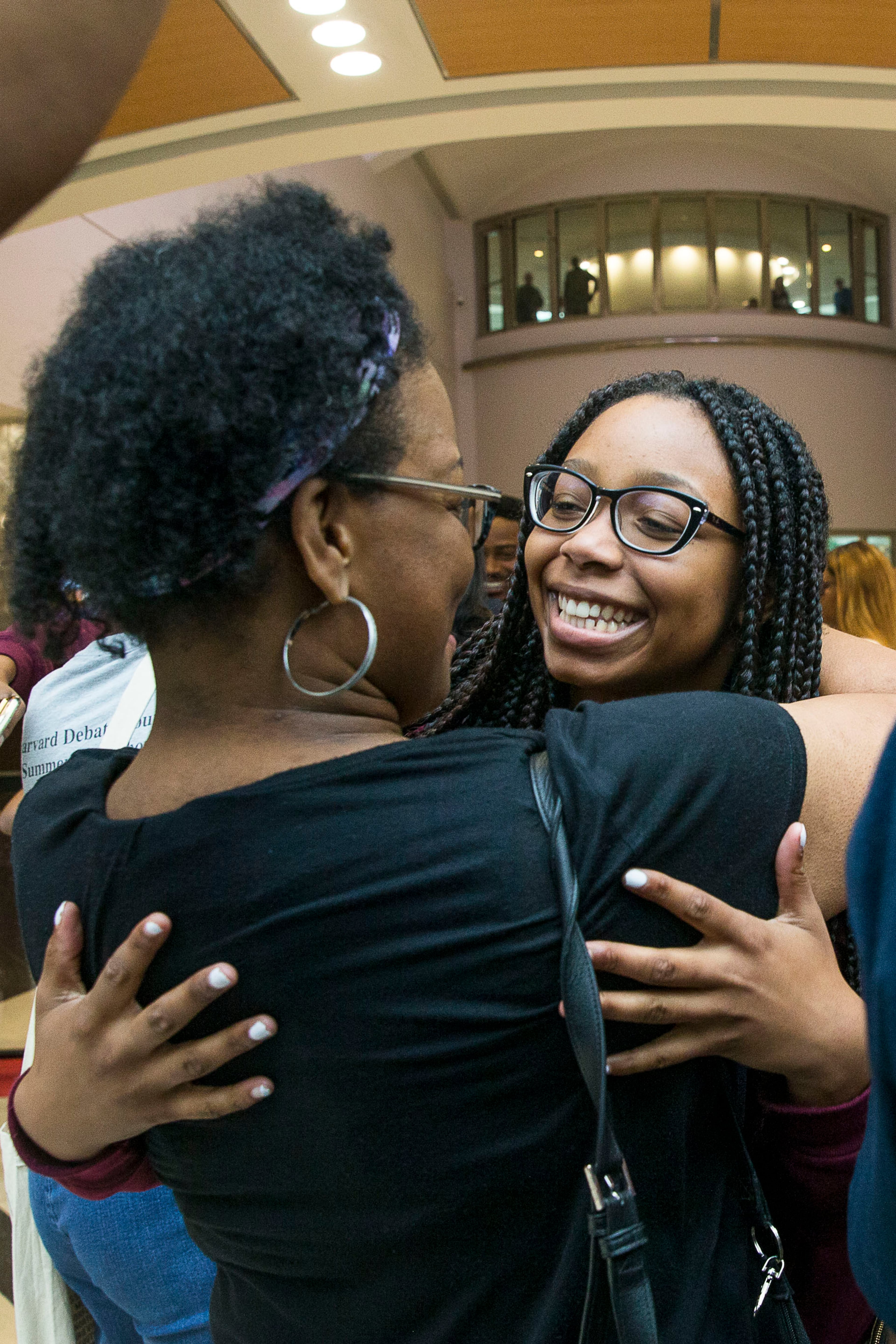 7/12/2019 -- Atlanta, Georgia -- Alexis Sims, of Eagles Landing High School, receives a hug as she and members of the Harvard Diversity Project arrive to family and friends in the domestic terminal at Hartsfield Jackson International Airport in Atlanta, Friday, July 12, 2019. The group, an Atlanta-based pipeline of the Harvard Debate Council, returned to Atlanta as champions of Harvard University's annual international debate tournament. Two of the students, Don Jr. Roman and Keith Harris achieved an unprecedented, undefeated record. (Alyssa Pointer/alyssa.pointer@ajc.com)