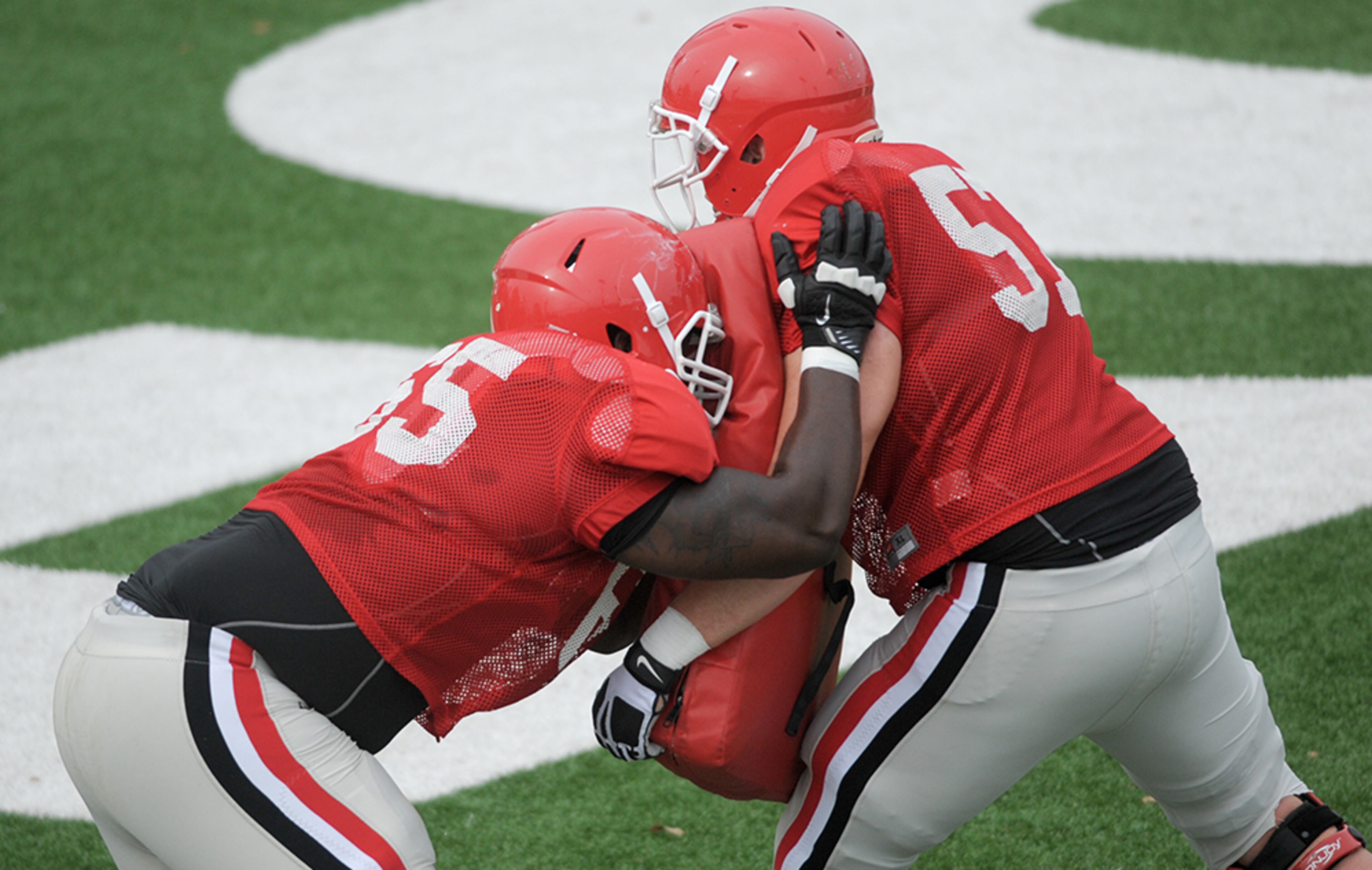 Georgia offensive linemen practice blocking during a Georgia spring football practice on Thursday, March 26, 2015, in Athens.