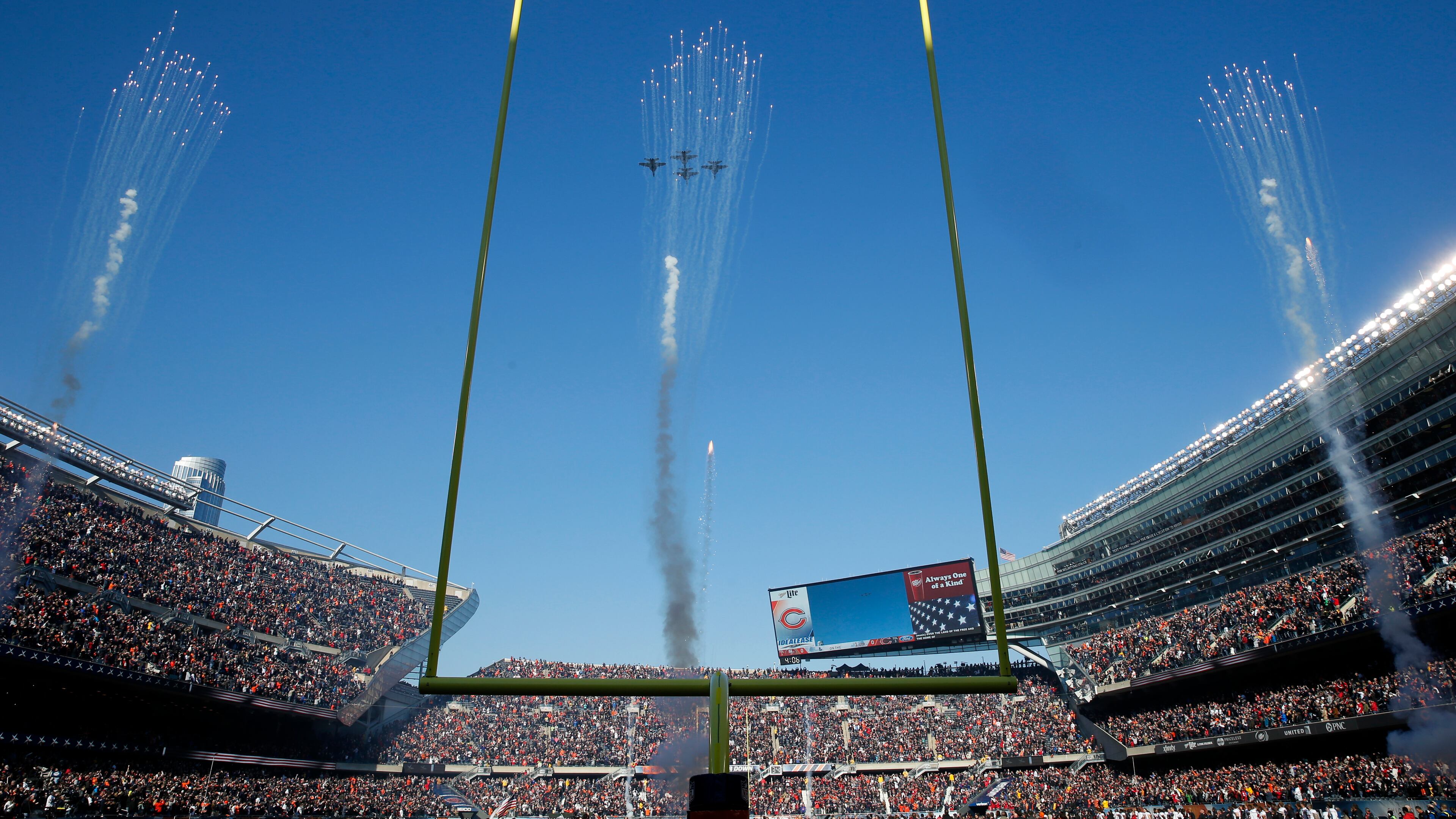 Military planes fly over Soldier Field before an NFL football game between the Chicago Bears and the San Francisco 49ers, Sunday, Dec. 6, 2015, in Chicago. (AP Photo/Charles Rex Arbogast)
