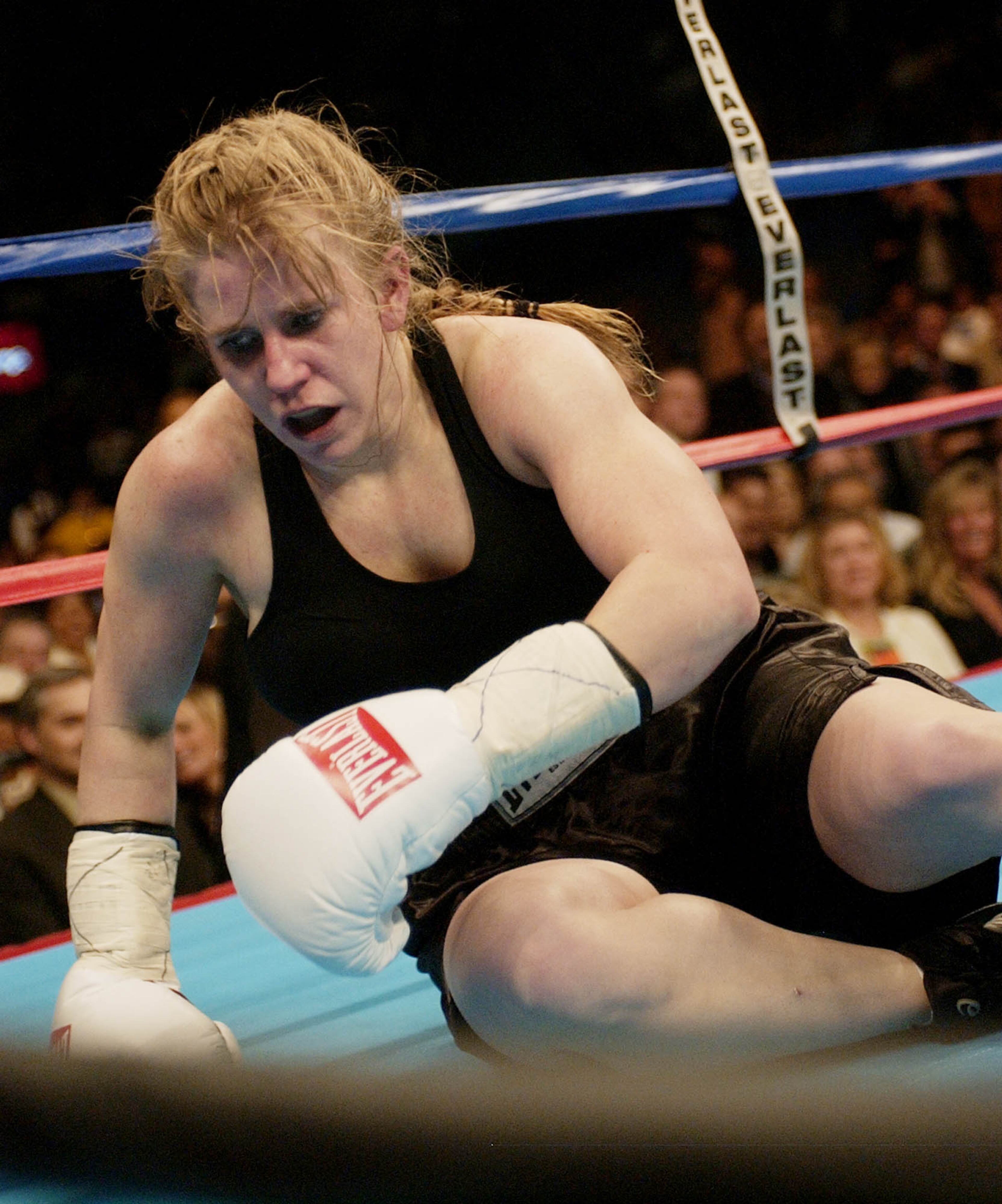 Tonya Harding of Vancouver, Wash., tries to get up off the mat after falling with opponent Samantha Browning of Mantachie, Miss., during their professional debut bout, Saturday, Feb. 22, 2003, in Memphis, Tenn. Browning defeated Harding in a split decision. (AP Photo/Dave Martin)