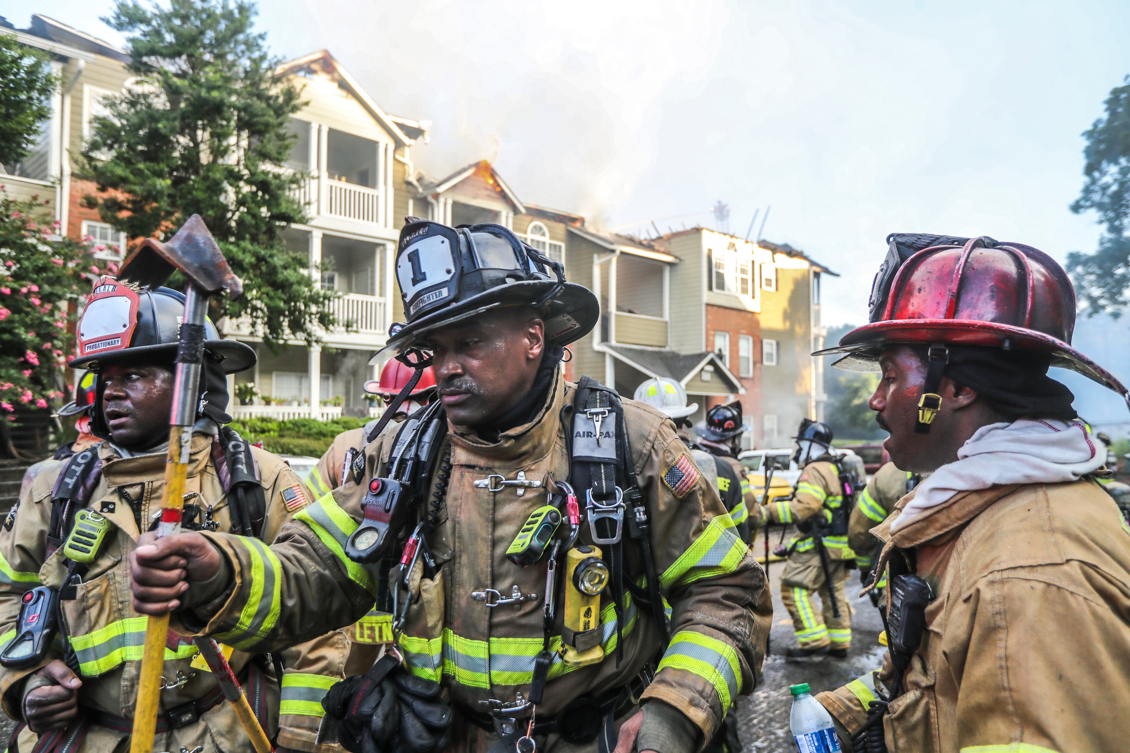 July 18, 2022 DeKalb County: All residents of a Brookhaven apartment building were able to escape their homes safely when a massive blaze broke out early Monday morning, July 18, 2022. No injuries were reported in the fire at the Evergreen Lenox Park apartments, which sent huge flames and smoke high into the air above nearby Roxboro and North Druid Hills roads at the start of the morning commute. Everyone inside the building evacuated before the first crews arrived about 6:30 a.m., thanks in large part to the effort of one man. Yusuf Thorne was on his way into work when he heard a subtle cracking sound and spotted the fire coming from an apartment on the third floor. Thorne said he called 911, connected with a dispatcher, and immediately hung up to begin knocking on his neighborsÕ doors. He escorted one woman to safety and went back again to try to wake another neighbor. ÒHe eventually came out,Ó Thorne said. ÒI was going to have to kick the door down if they didnÕt get out of there.Ó Thorne said he had to continue knocking on doors as the fire spread. According to fire Capt. Jaeson Daniels, the flames reached an attic space and eventually destroyed several third-floor units. ÒIt started on the third floor so the fire didnÕt have very far to travel to get to the attic, really saving the apartments on the bottom from fire damage,Ó Daniels said. ÒBut unfortunately, the top apartments had severe fire damage.Ó He estimates about 18 families will lose their homes and need the assistance of the American Red Cross for temporary lodging and other emergency needs. Fire crews dug through the debris Monday morning to learn the extent of the damage. Investigators have not determined the fireÕs cause or exact origin. (John Spink / John.Spink@ajc.com)