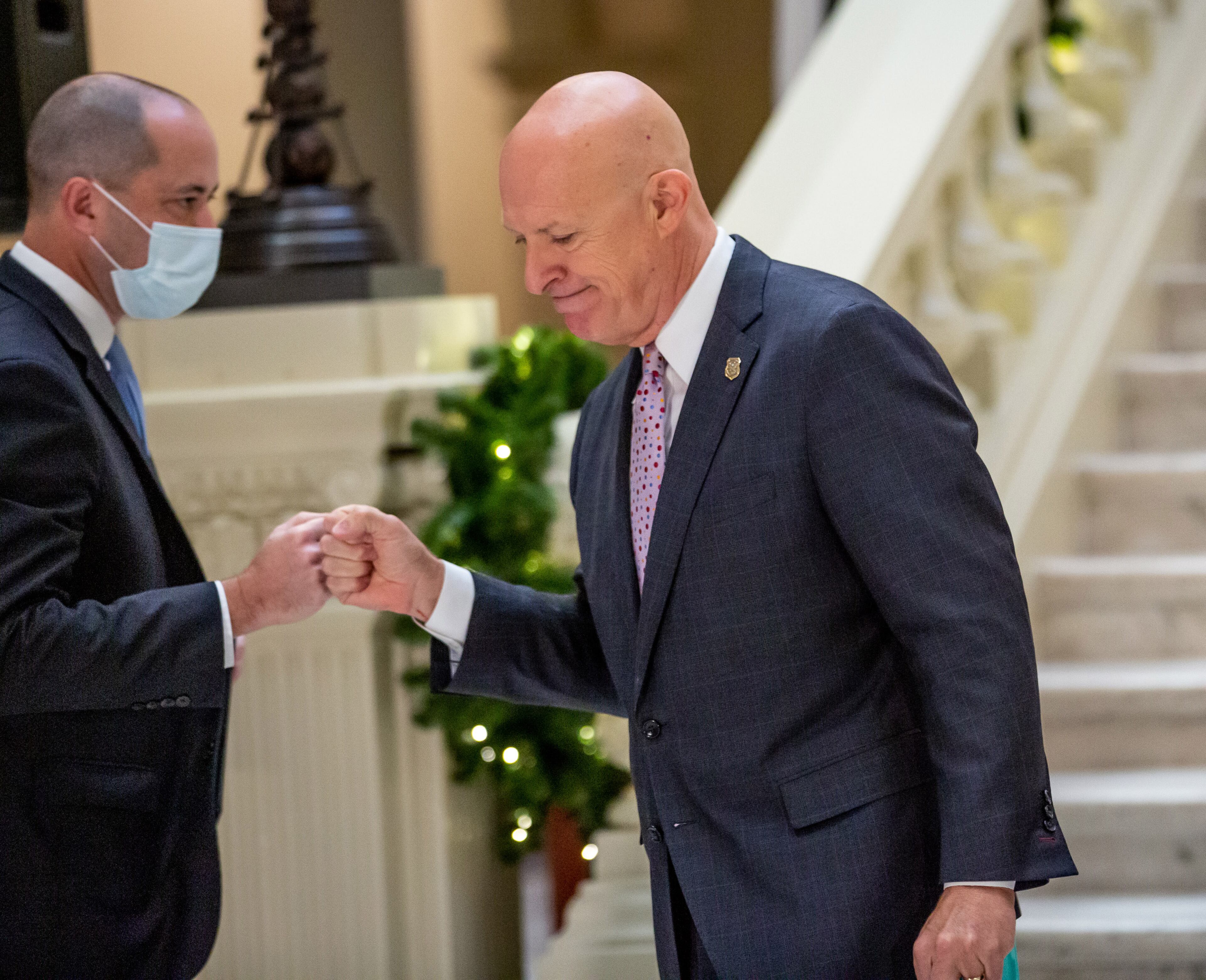 Attorney General Chris Carr (L) fist bumps GBI Director Vic Reynolds during a press conference at the State Capital Tuesday, November 24, 2020. STEVE SCHAEFER / SPECIAL TO THE AJC