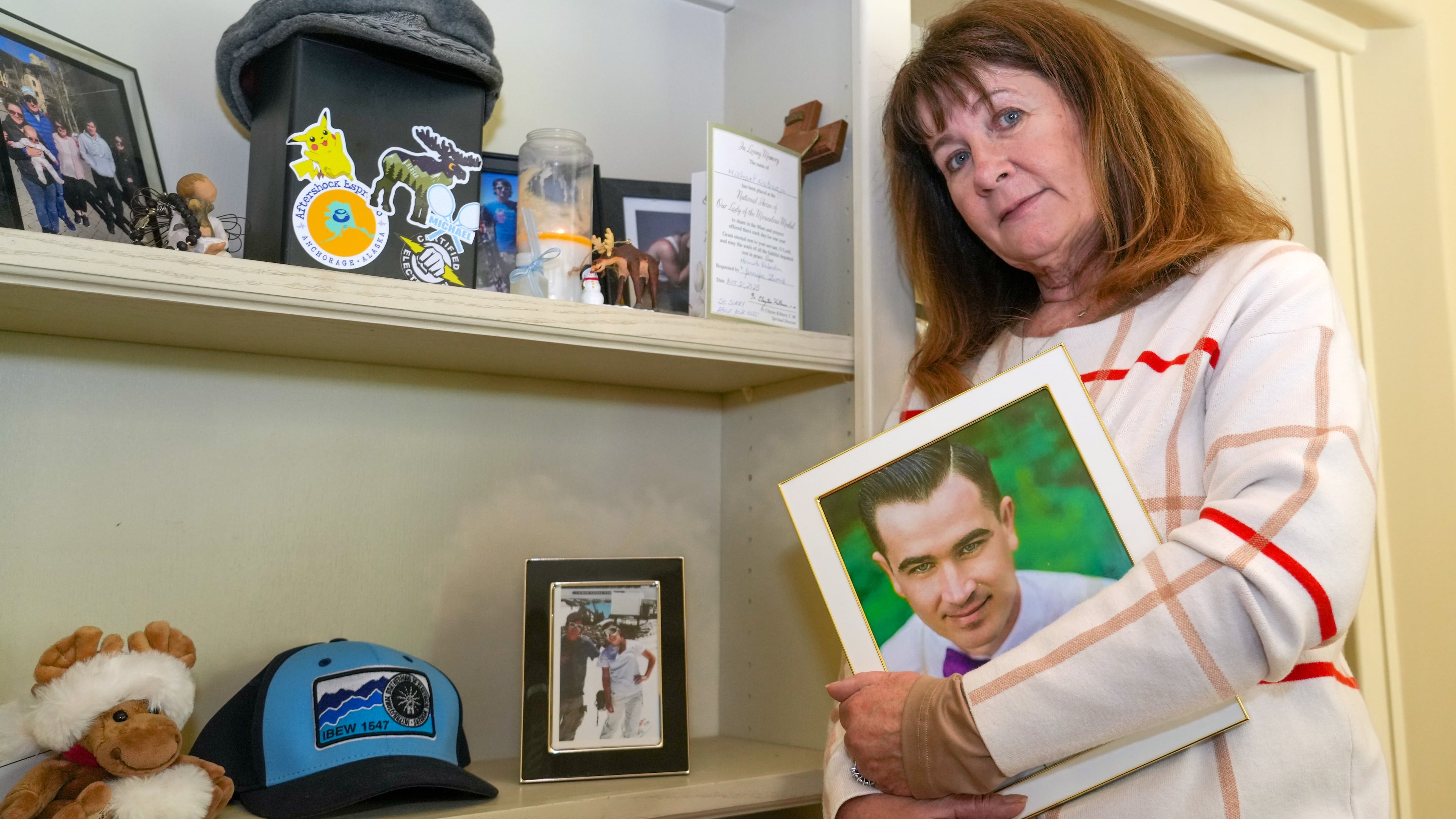Kelley Nalewaja stands by a memorial for her son, Michael Nalewaja, seen in the photo, who died after unknowingly taking a lethal cocktail of fentanyl and carfentanil in November 2025, at her home in El Dorado Hills, Calif., Thursday, April 16, 2026. (AP Photo/Rich Pedroncelli)