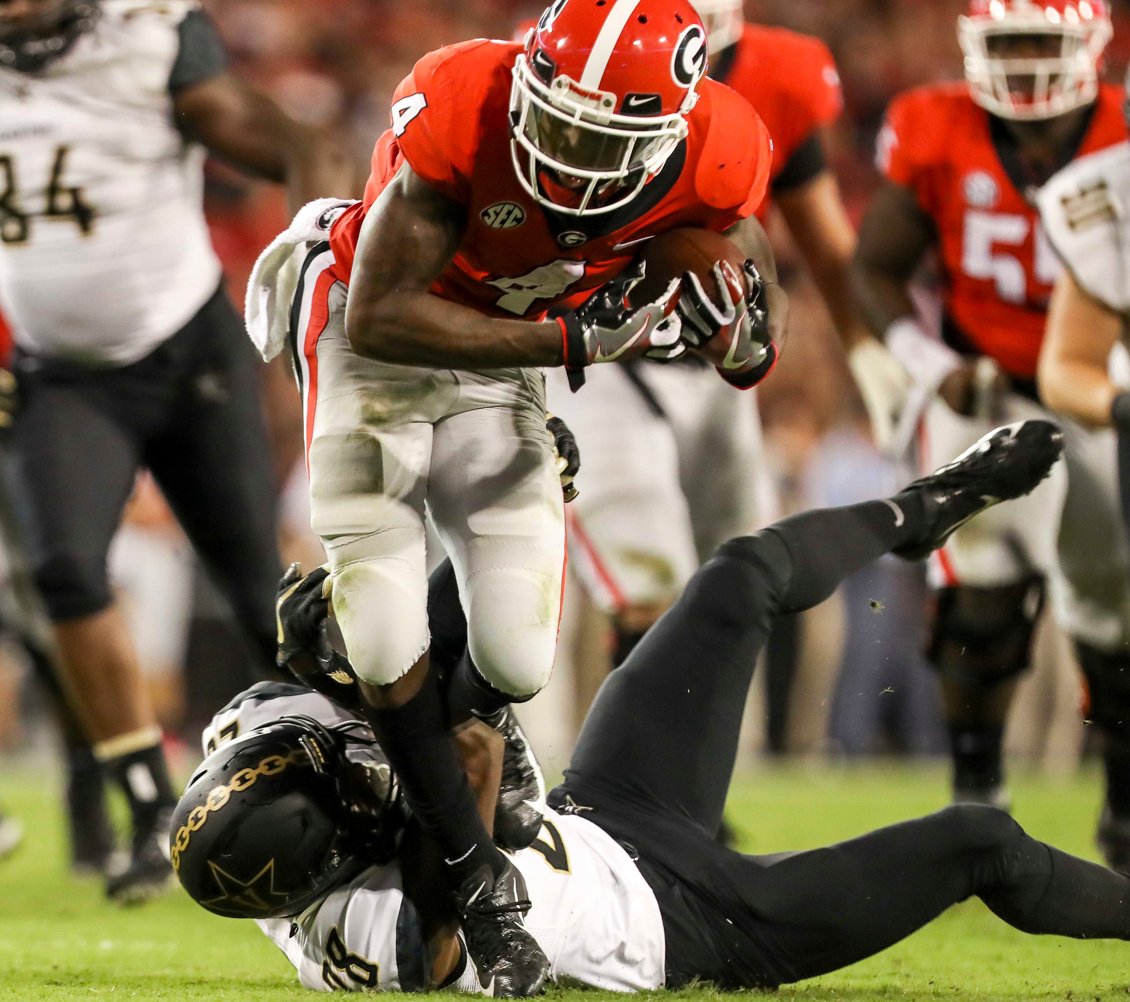 10/06/2018 -- Athens, Georgia -- Georgia wide receiver Mecole Hardman (4) is tackled by Vanderbilt defensive back Allan George (28) during the second quarter of an NCAA college football game at Sanford Stadium in Athens, Saturday, October 6, 2018. (ALYSSA POINTER/ALYSSA.POINTER@AJC.COM)
