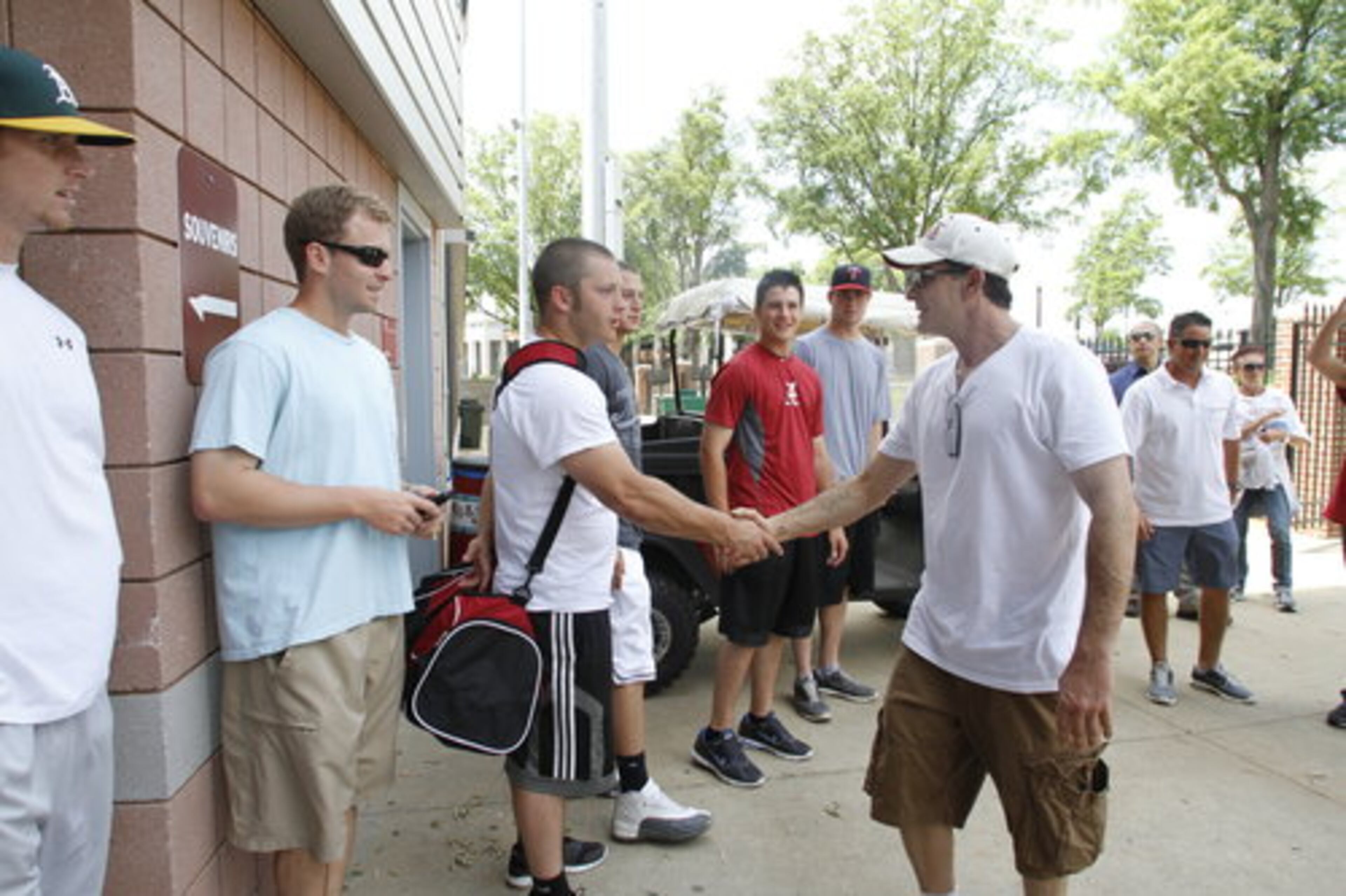Sheen shakes hands of University of Alabama baseball players. "I want to bring some money, hope, faith and healing to the area," said Sheen, the former star of the sitcom "Two and a Half Men."