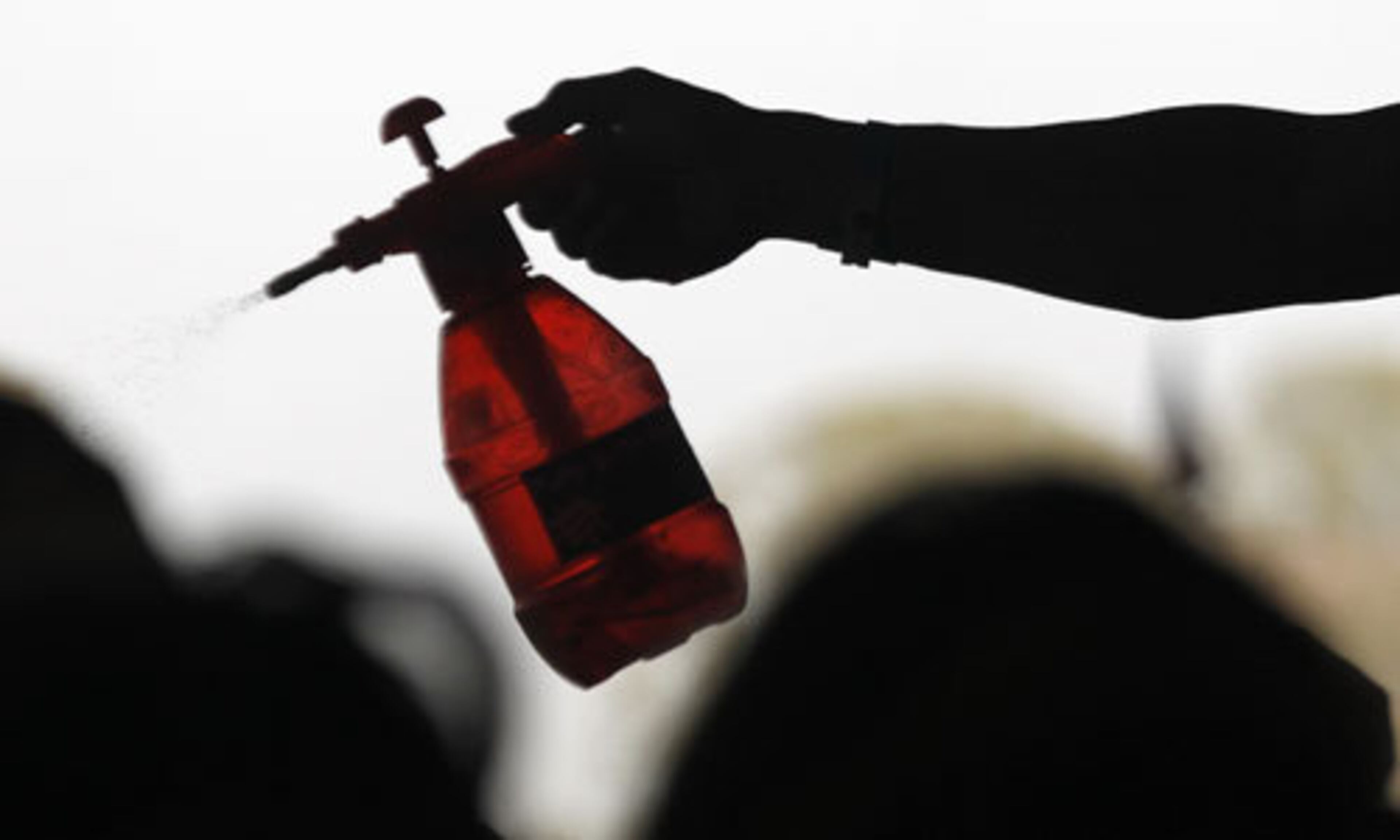 A friendly hand with a bottle of water sprays attendees. Scorching temperatures accompanied the four-day music festival.