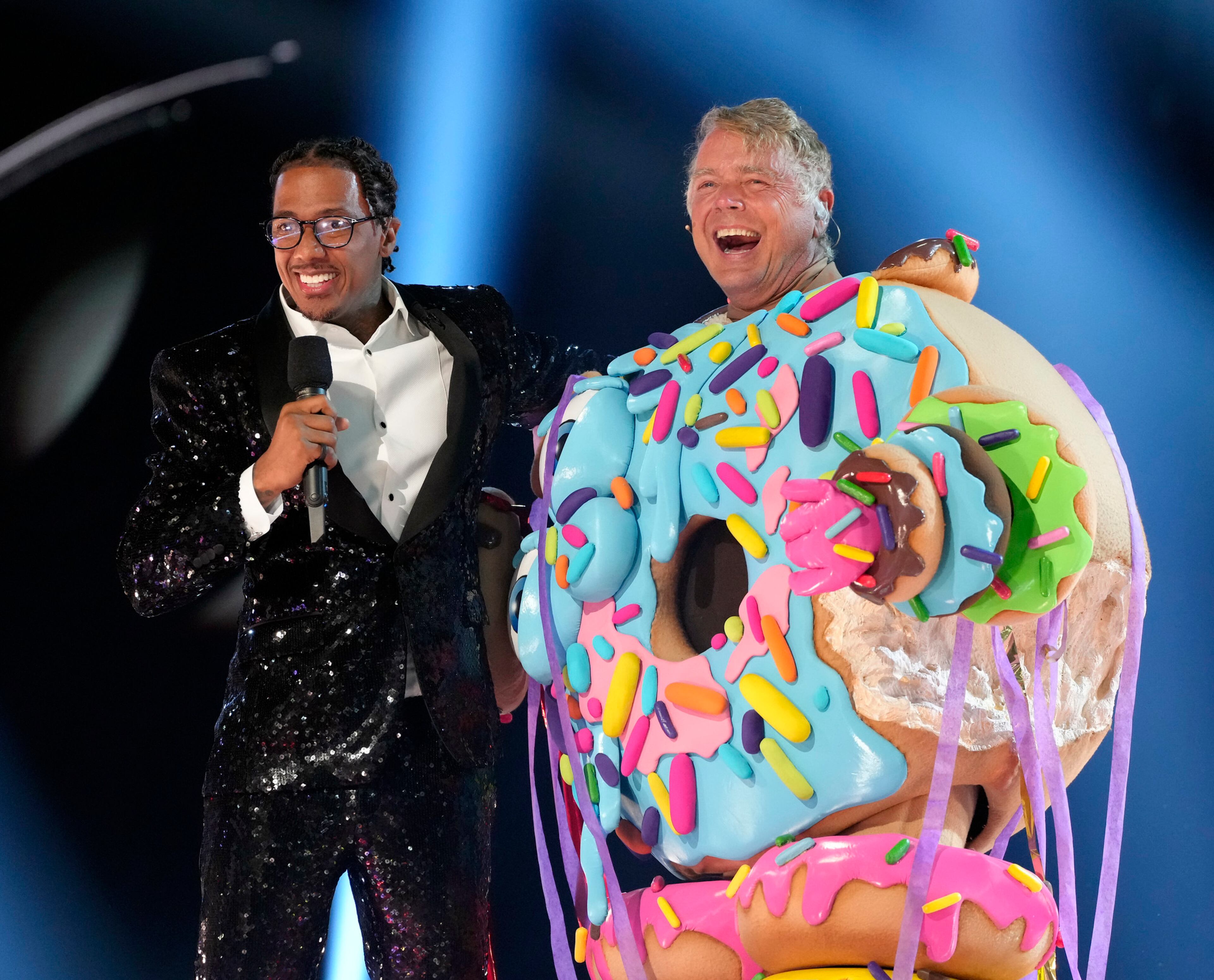THE MASKED SINGER: L-R: Nick Cannon and John Schneider in the two-hour season finale episode of THE MASKED SINGER airing Wednesday, Dec. 20 (8:00-10:00 PM ET/PT ) on FOX. CR: Michael Becker / FOX. ©2023 FOX Media LLC.
