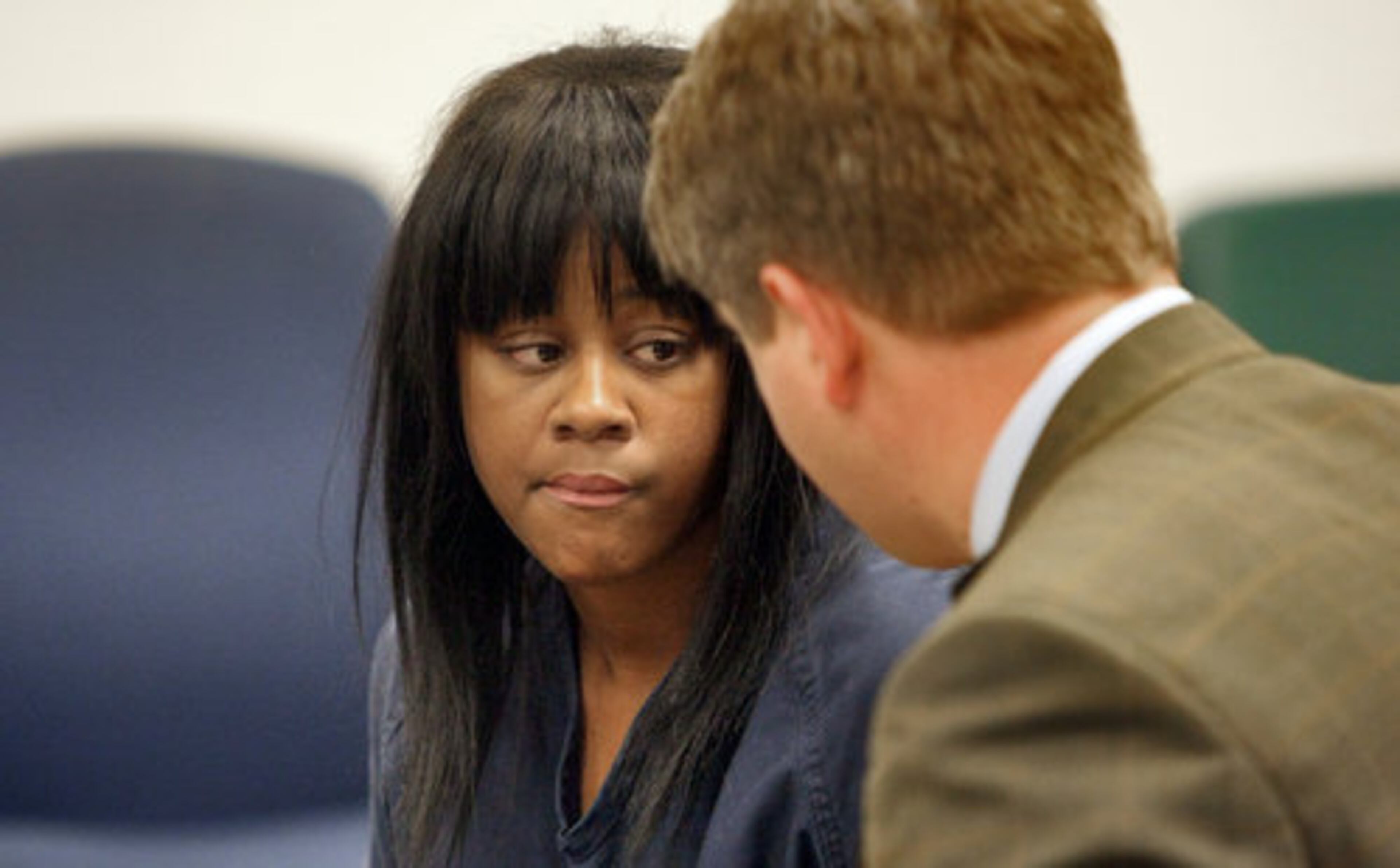 Suspect Aimee Michael listens to her attorney, Scott Smith, in court in April.