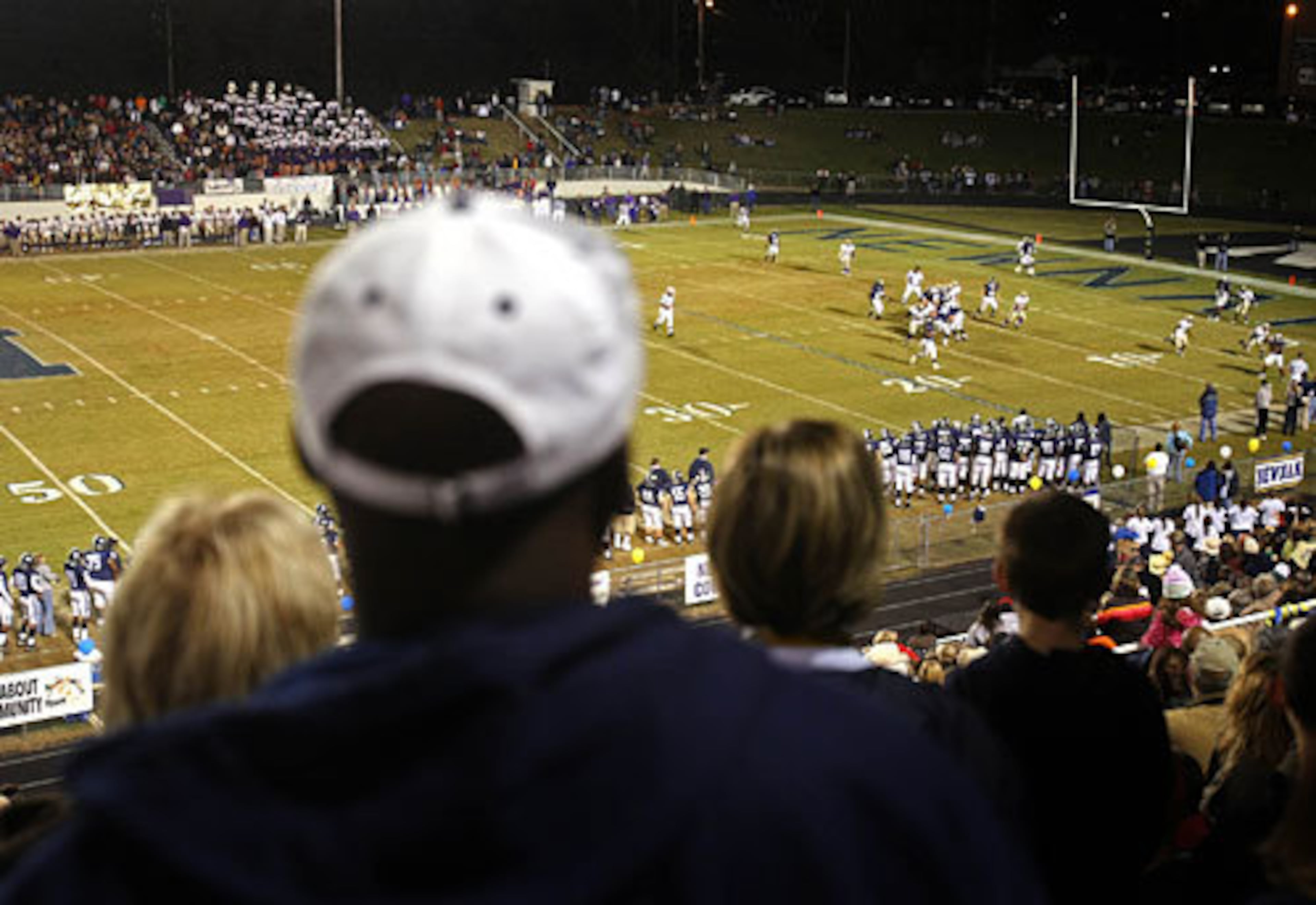 Al (in white cap) helps his sons Alec and Alexander learn from the mistakes he made as a high school football player at Newnan. Al, a 1977 Newnan graduate, got into trouble with the Newnan principal because he made bad decisions and was unable to finish his own promising football career as a running back and linebacker.