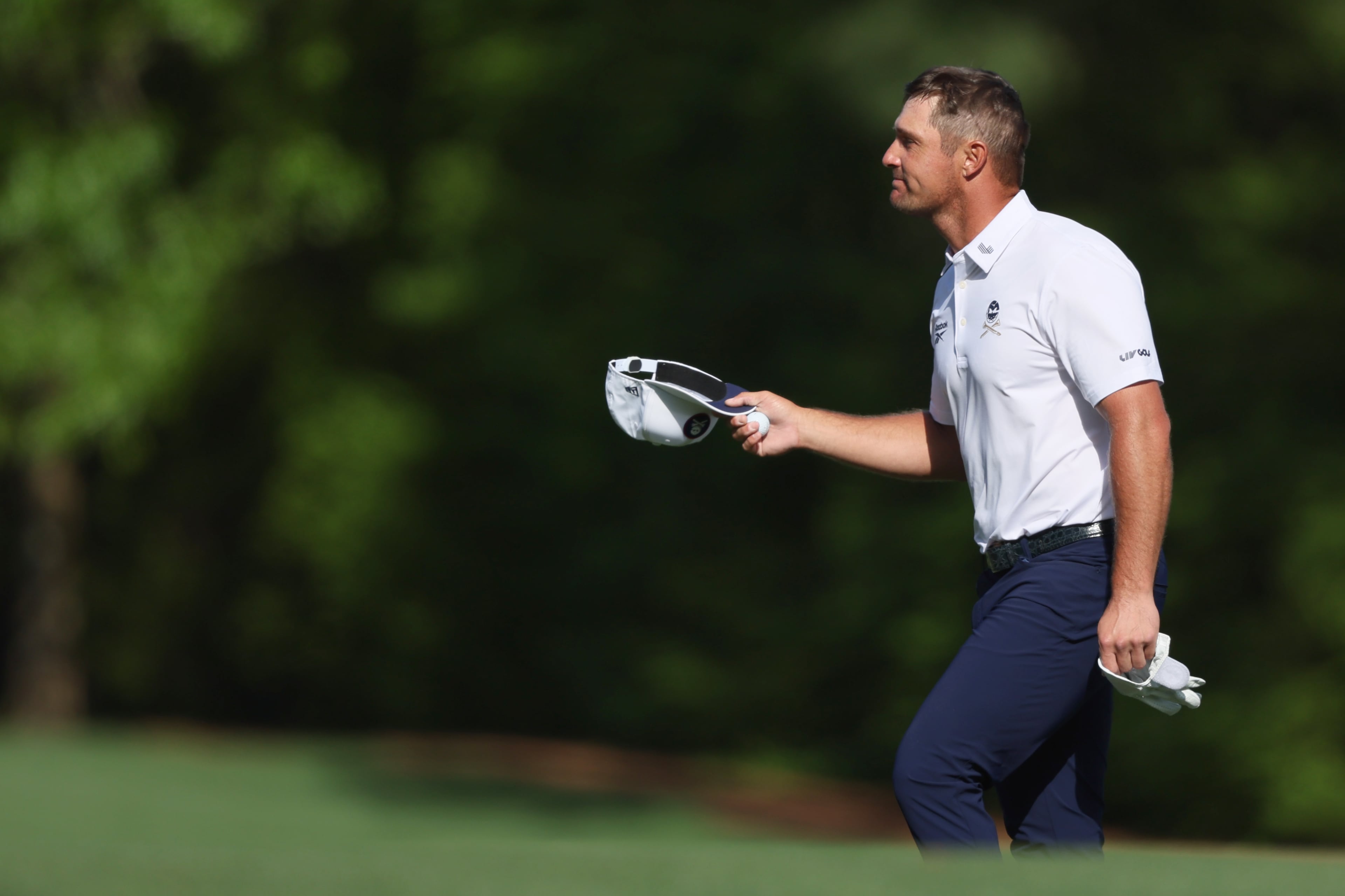 Bryson DeChambeau acknlowedges patrons as he walks up 12th fairway during third round of the Masters golf tournament, at Augusta National Golf Club, Saturday, April 12, 2025, in Augusta, Ga. (Jason Getz / AJC)