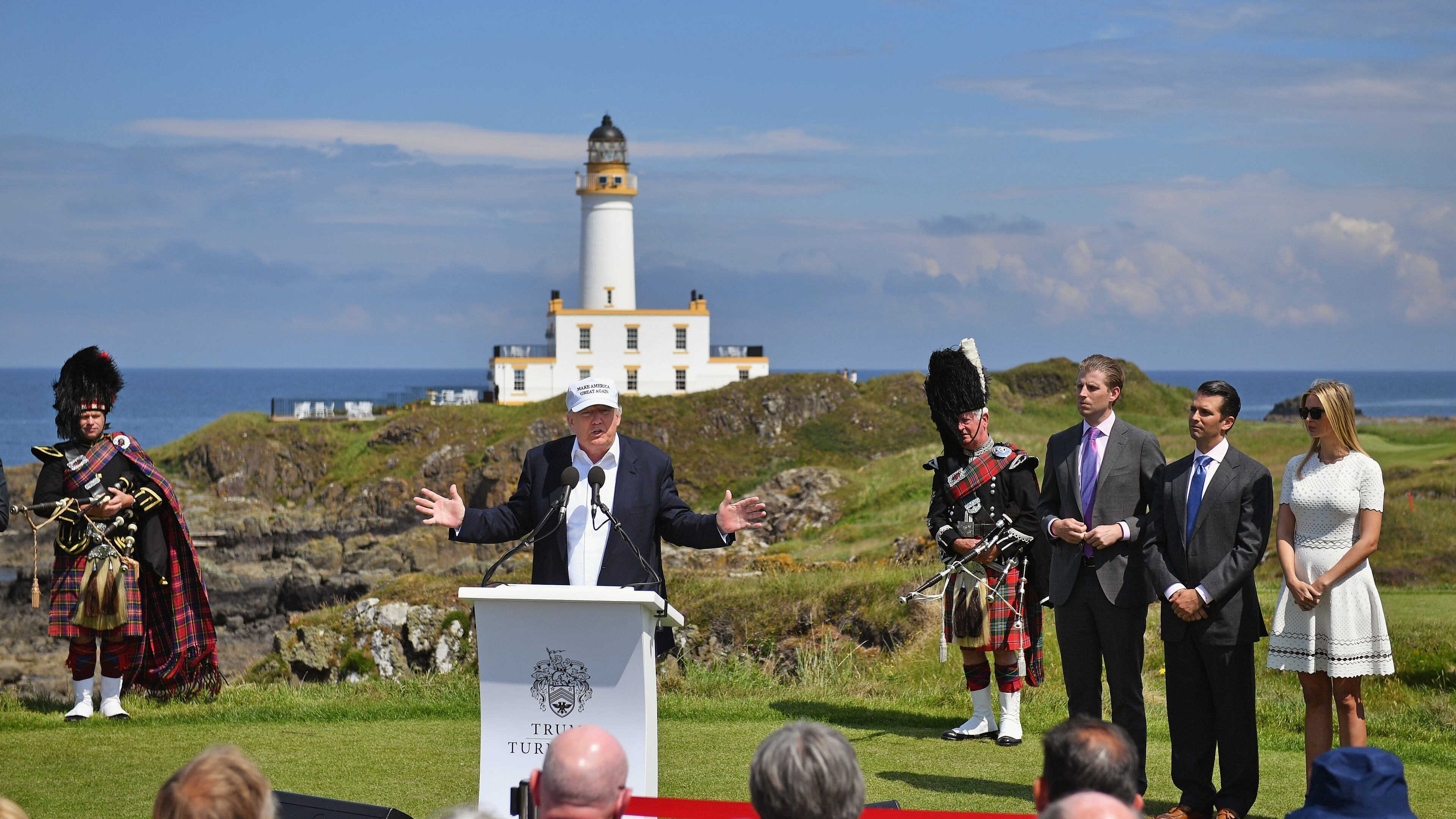 Presumptive Republican nominee for US president Donald Trump gives press conference on the ninth tee at his Trump Turnberry Resort surrounded by his family Eric Trump, Donald Trump Jr. and Ivanka Trump on Friday in Ayr, Scotland. Jeff J Mitchell/Getty Images