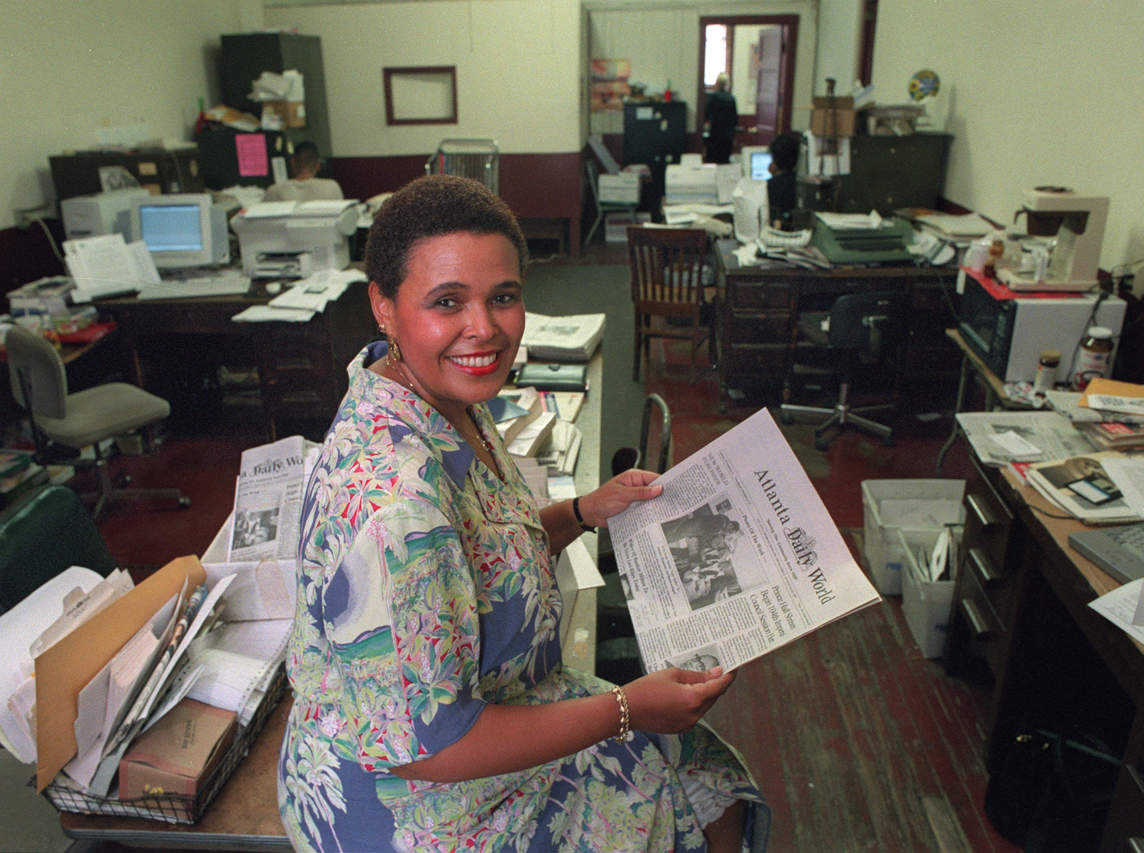 Alexis Scott Reeves, just after being named publisher of the Atlanta Daily World in 1997, sitting in the business office at Atlanta Daily World with a copy of that day's paper (8/14/97). (AJC Staff Photo/Charlotte B. Teagle)
