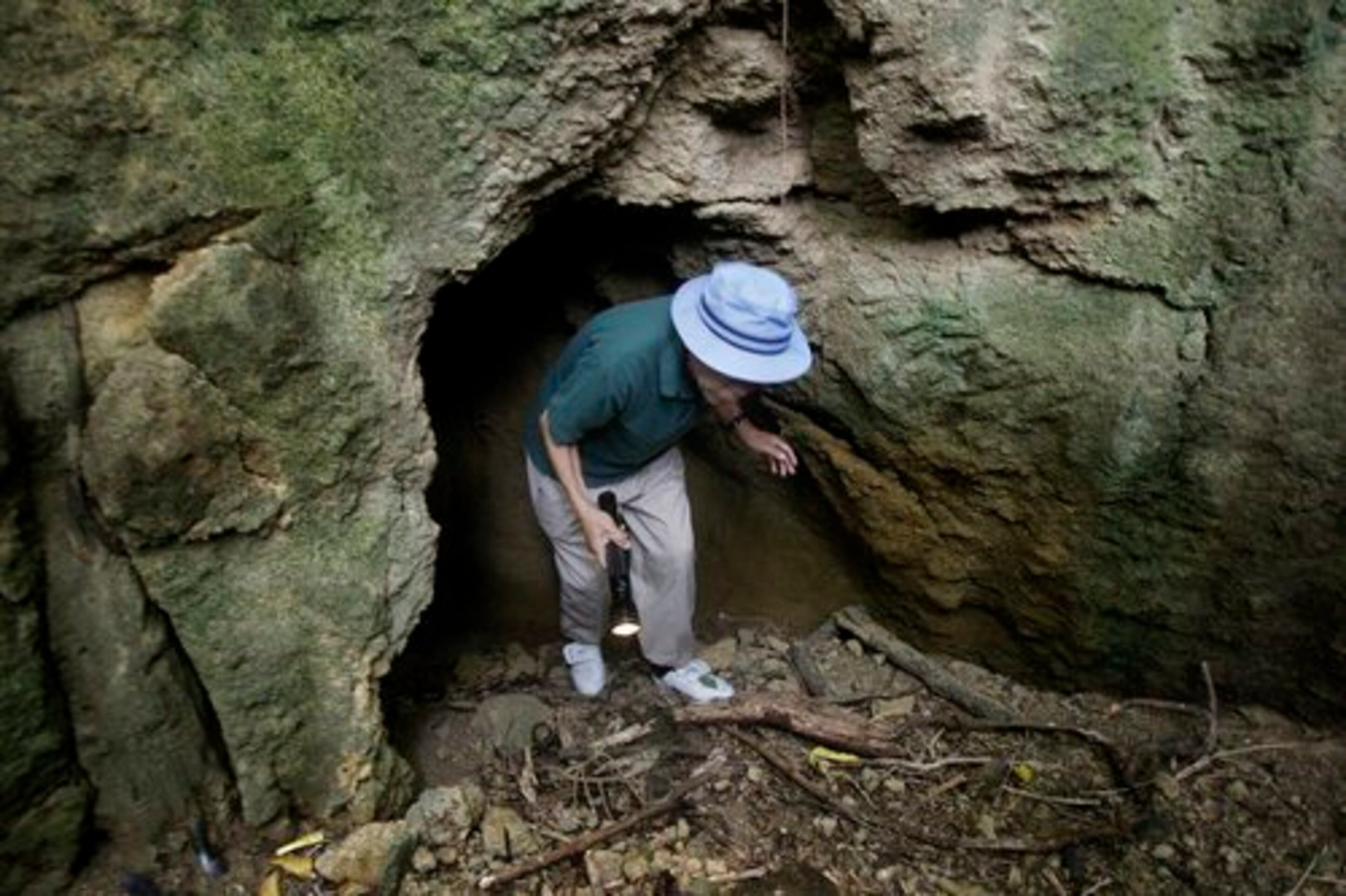 Tsuruji Akikusa, an 81-year-old Japanese WWII veteran and survivor of the battle of Iwo Jima, exits a cave where he says he lived for three months until his capture by U.S. forces.