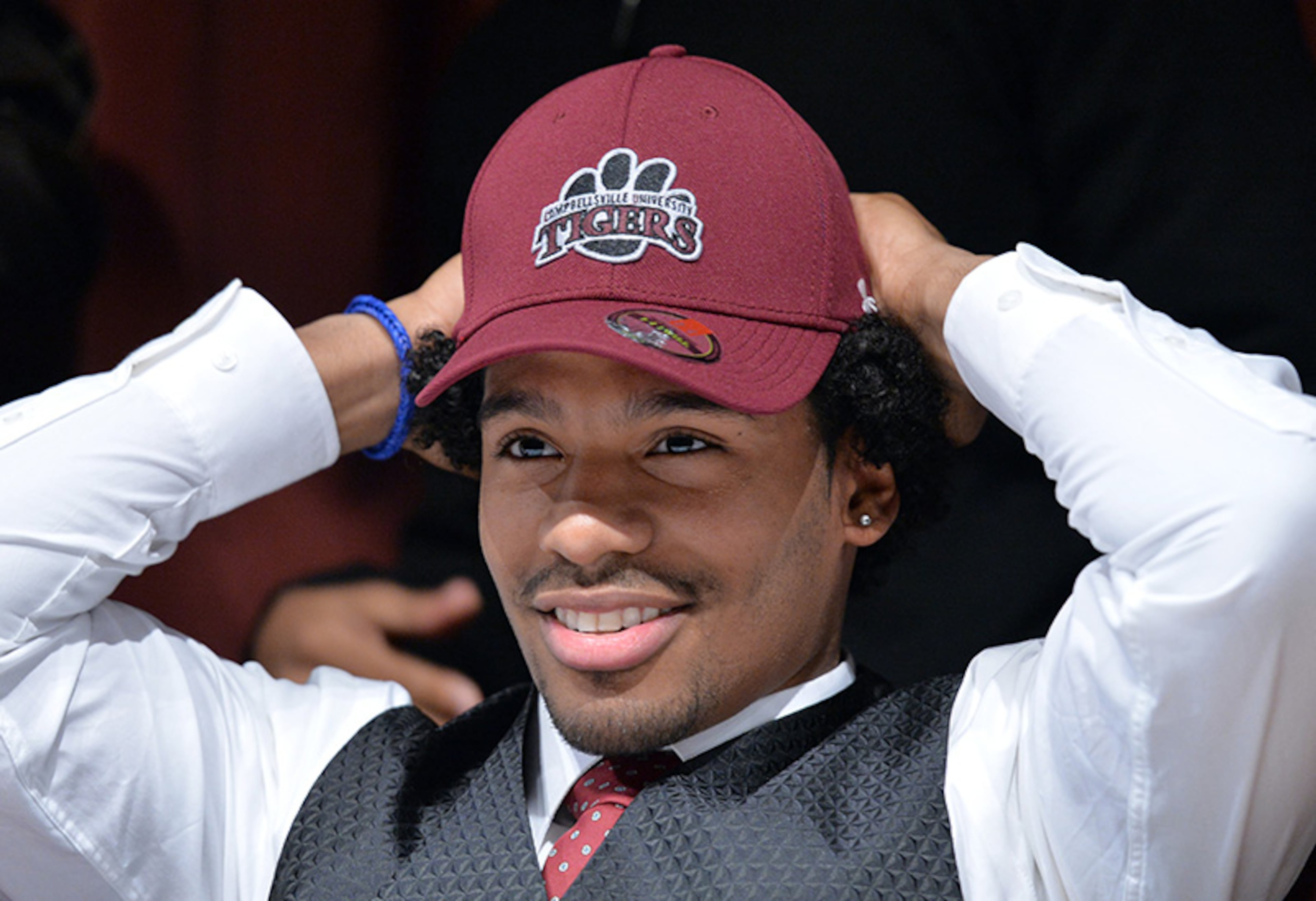 Malik Campbell picks Campbellsville putting on his hat during signing day at Tucker High School.