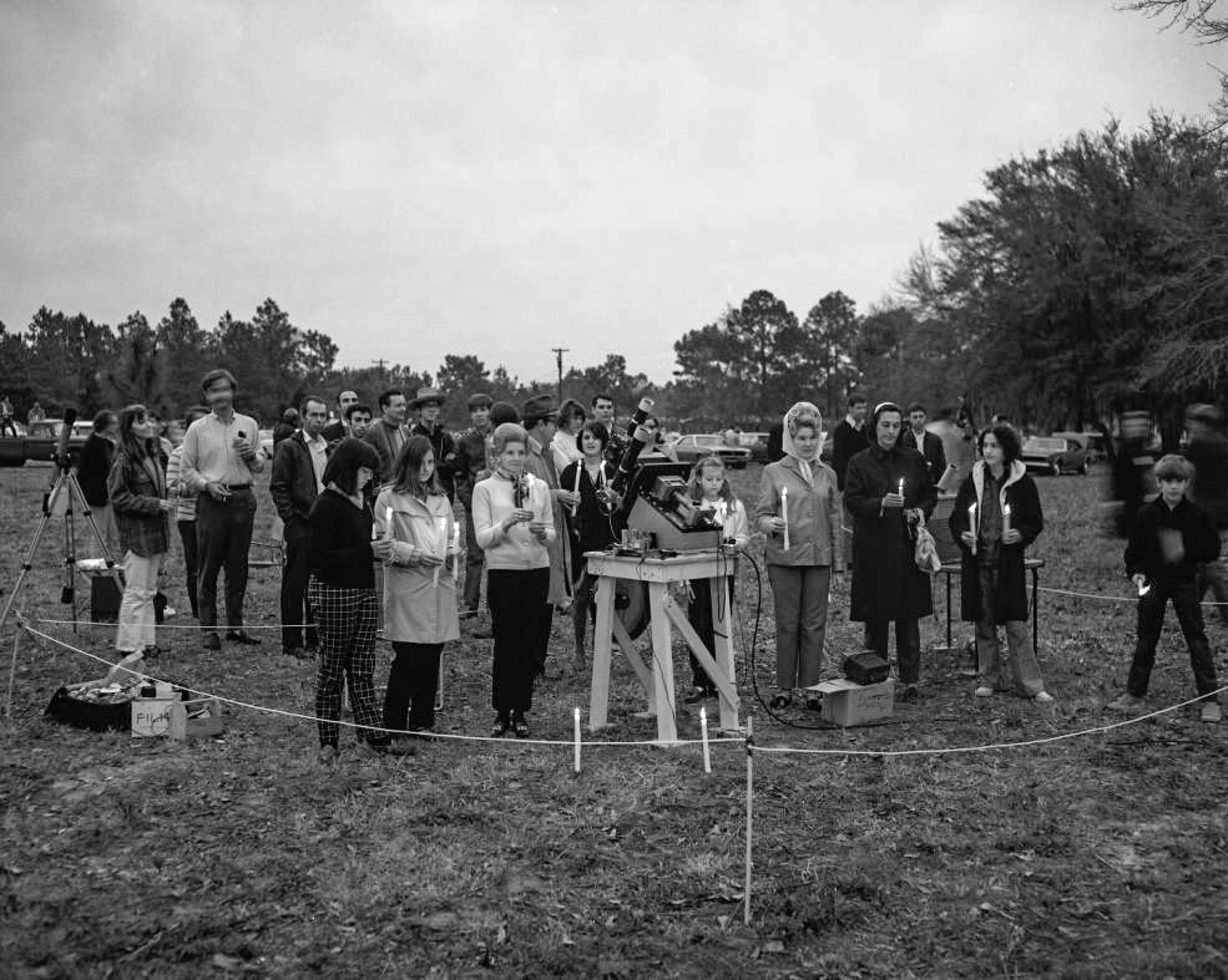 Astronomers hold candles at the moment of totality during the solar eclipse,March 7, 1970.