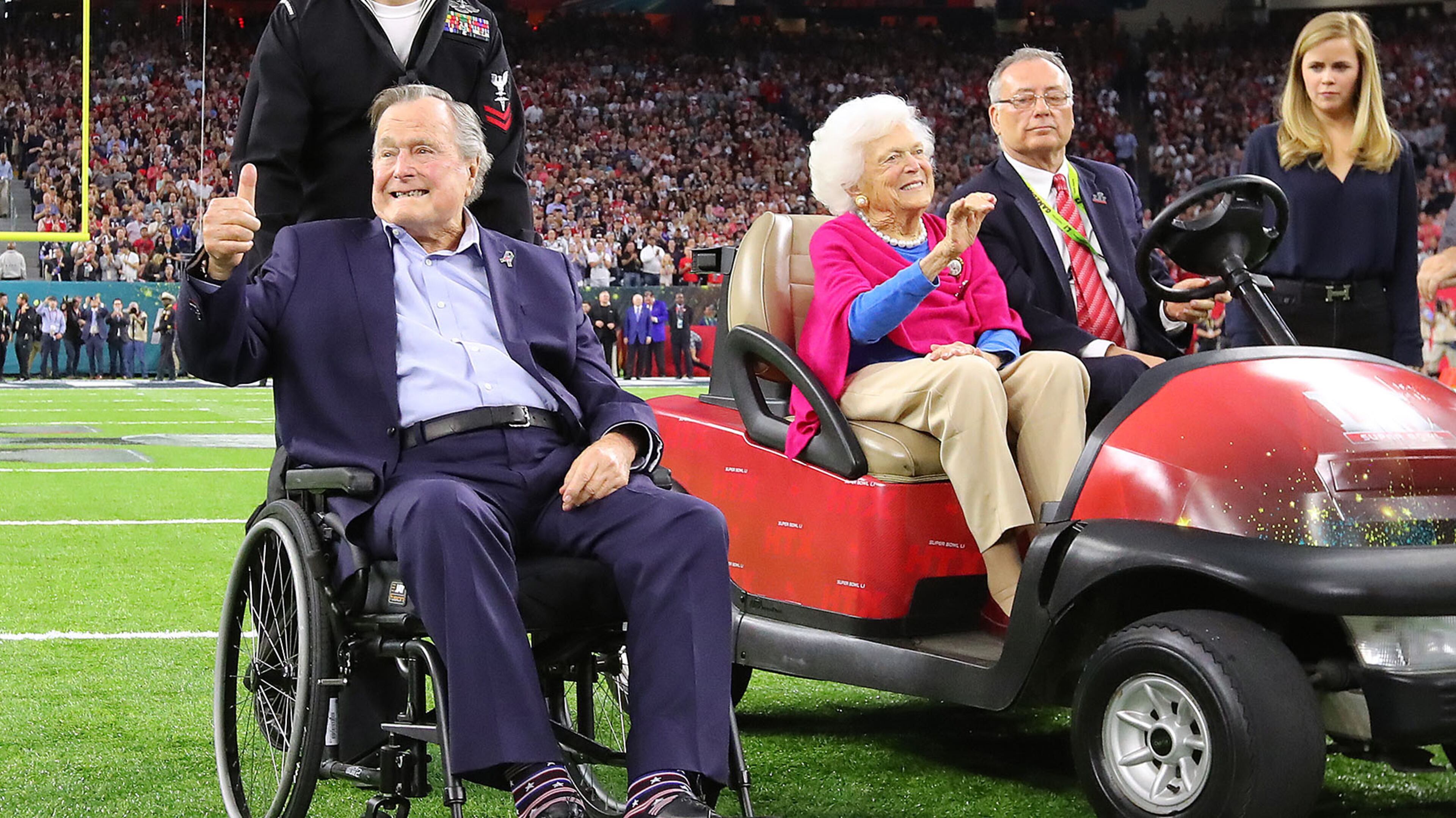 Former President George H.W. Bush gives the cheering crowd a thumbs up and former First Lady Barbara Bush waves as they take the field for the coin toss while the Atlanta Falcons meet the New England Patriots in Super Bowl LI at NRG Stadium in Houston, TX, Sunday, February 5, 2017. Curtis Compton/AJC