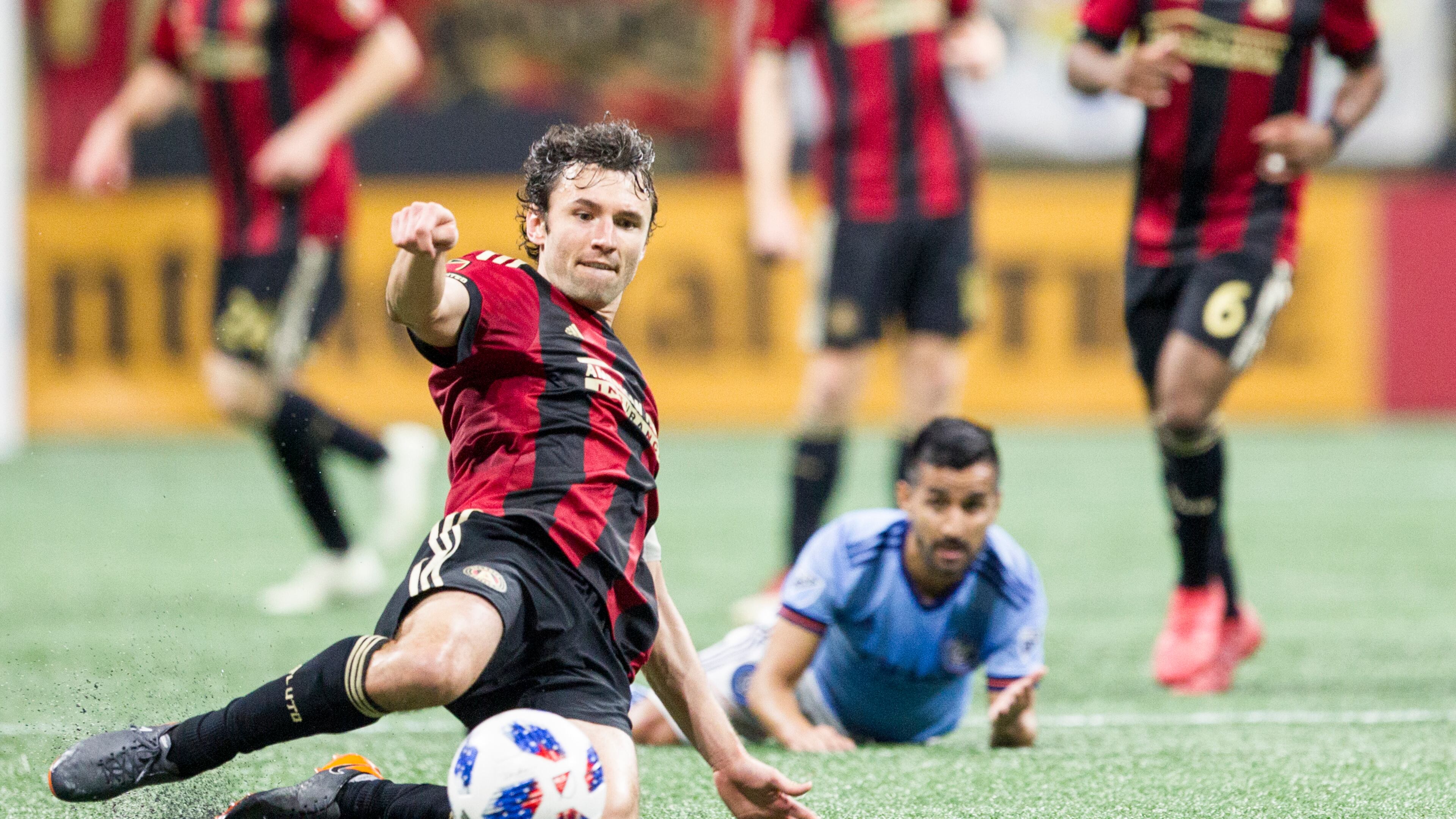 Atlanta United defender Michael Parkhurst (3) slides across the field to kick the ball during the match between NYC FC and Atlanta United Sunday, April 15, 2018, at Mercedes-Benz Stadium in Atlanta.