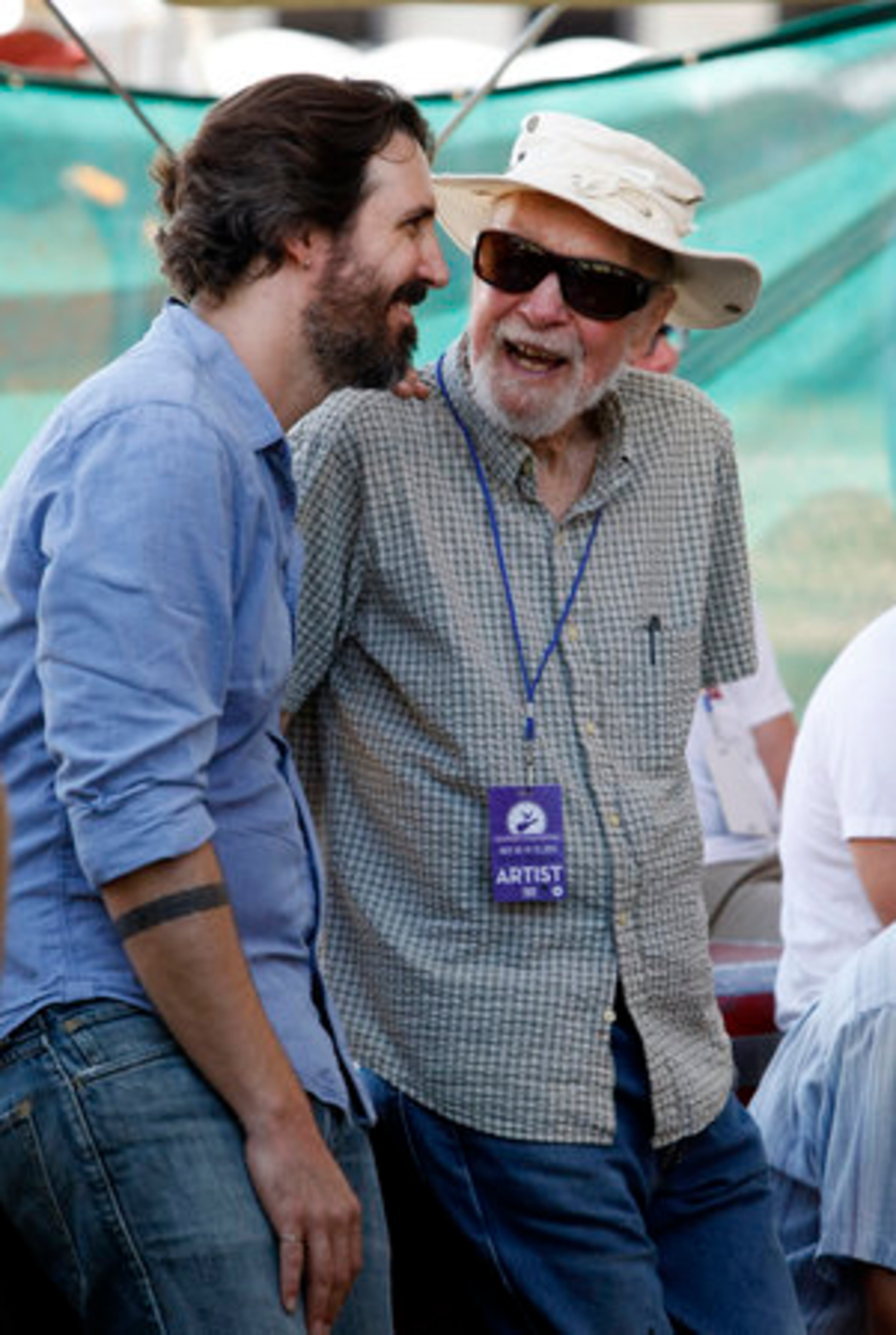 Folk singer Pete Seeger, right, talks backstage with his grandson Tao Rodriguez-Seeger.