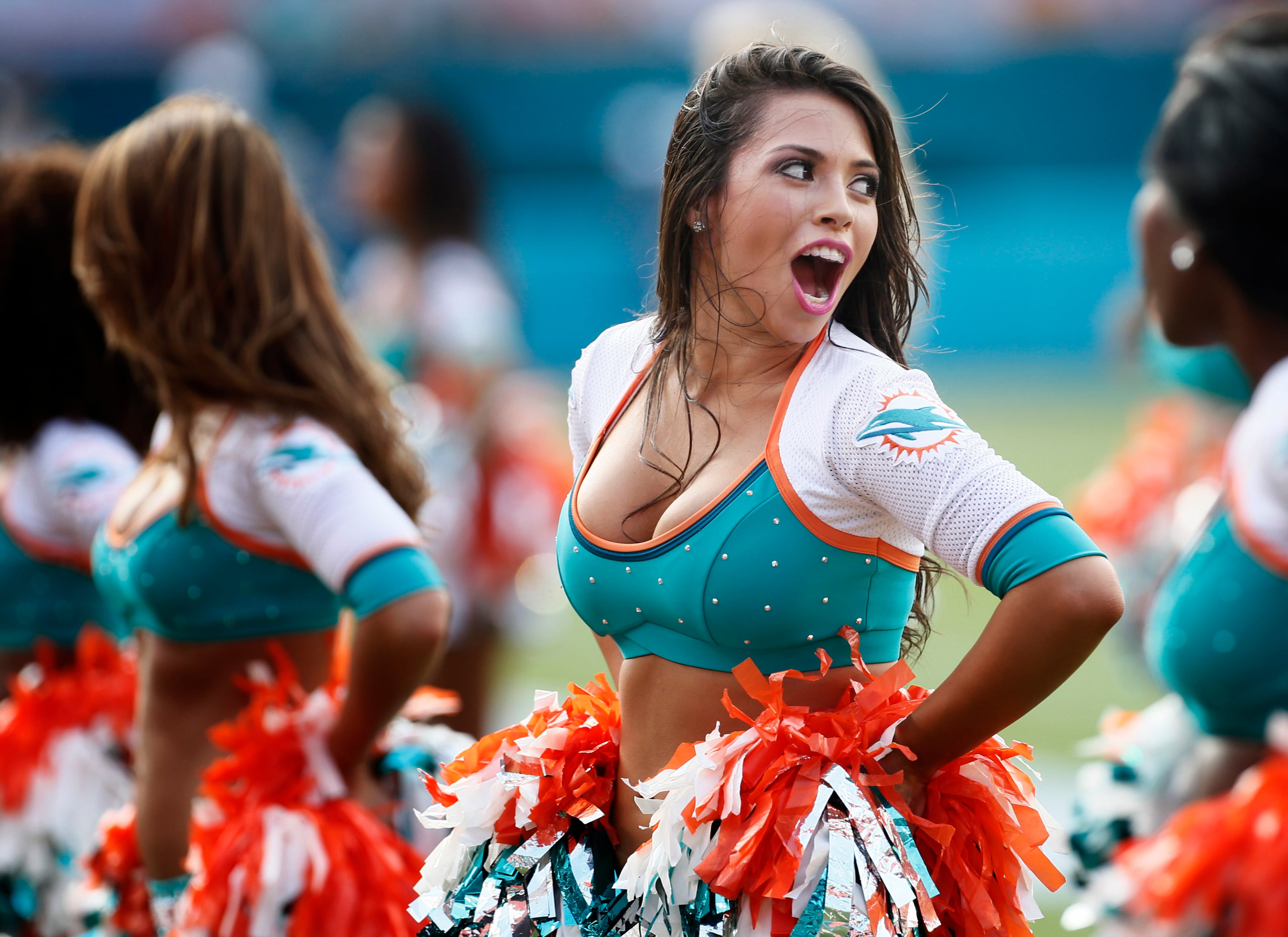 A Miami Dolphins cheerleader looks back onto the field.
