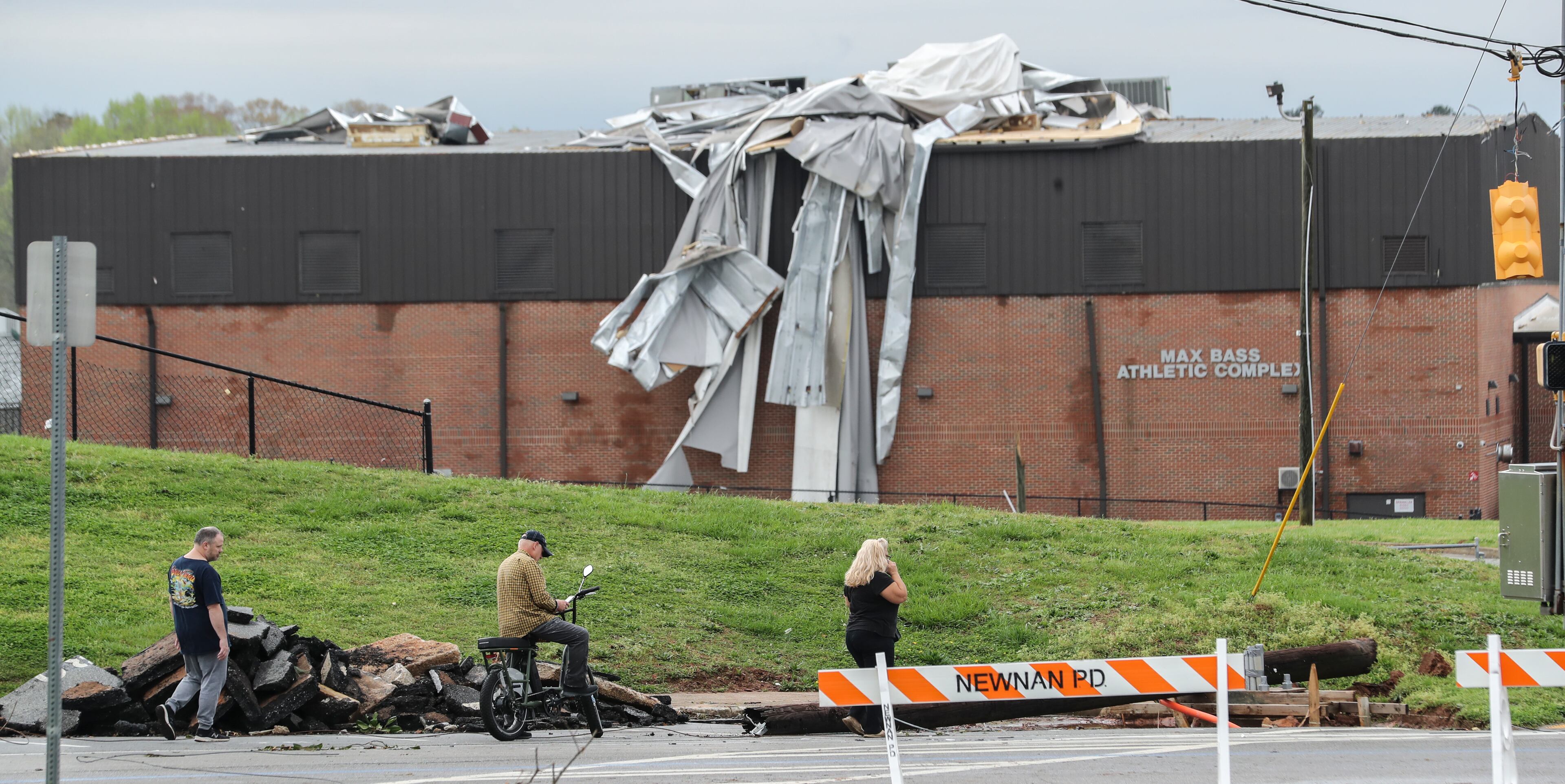 March 26, 2021 Coweta: Surveying the damage on LaGrange Street. Storms that rolled through North Georgia late Thursday into Friday, March 26, 2021left a path of destruction, killing one person and injuring others. Most of metro Atlanta was spared from major damage, but Bartow and Polk counties ― in northwest Georgia ― and Coweta County south of Atlanta took the brunt of the impact. Coweta firefighters and police officers worked in the dark to rescue people trapped in their homes and clear roads after a powerful storm slammed the area early Friday. Daylight gave emergency crews a look at the damage, summed up in one word: catastrophic. The city of Newnan, including the historic district and Newnan High School, was hit especially hard. (John Spink / John.Spink@ajc.com)