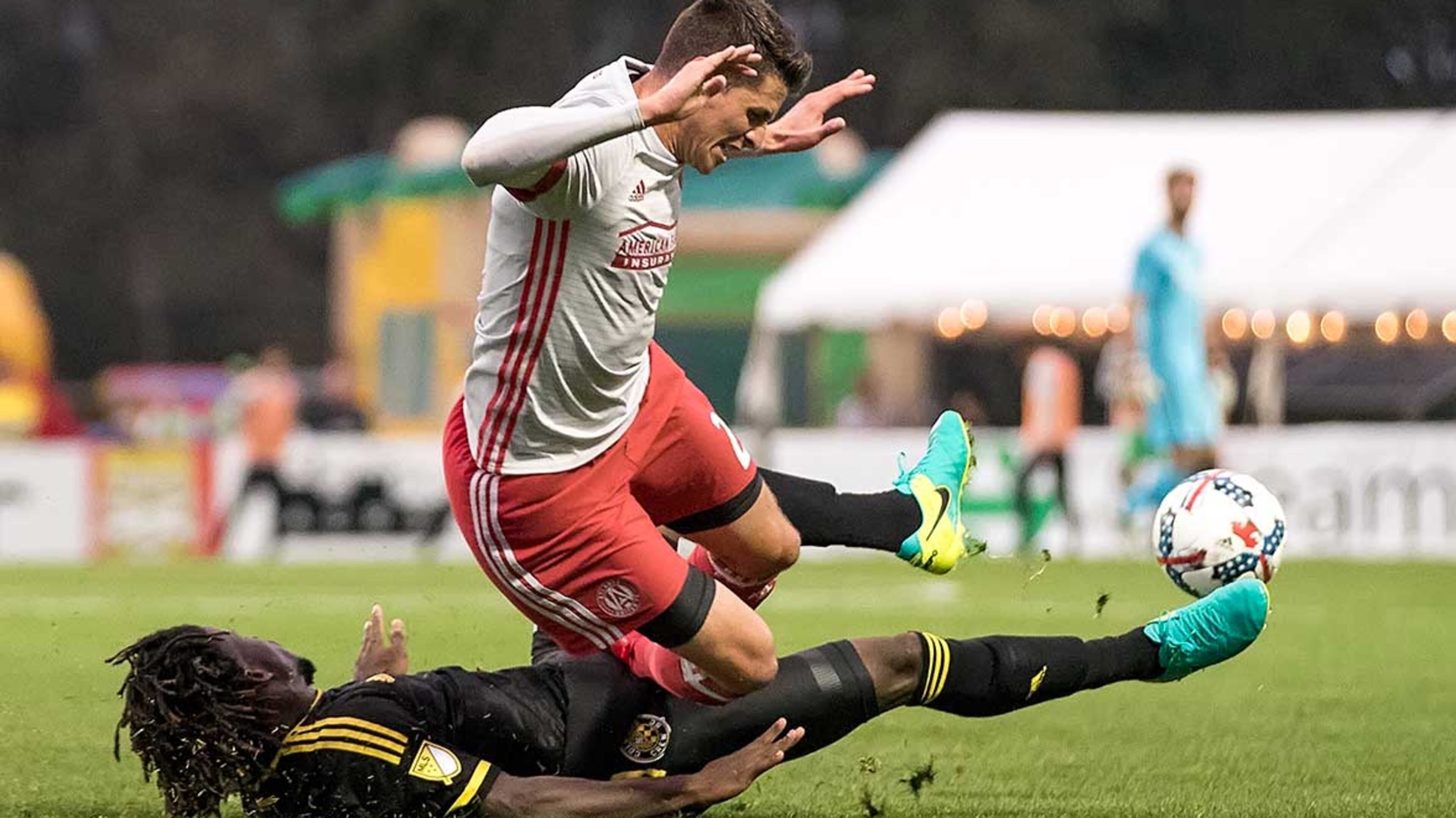 Columbus Crew defender Lalas Abubakar(#17) lays down a hard tackle on United's Mark Bloom (#21) during their showdown last month in Charleston.