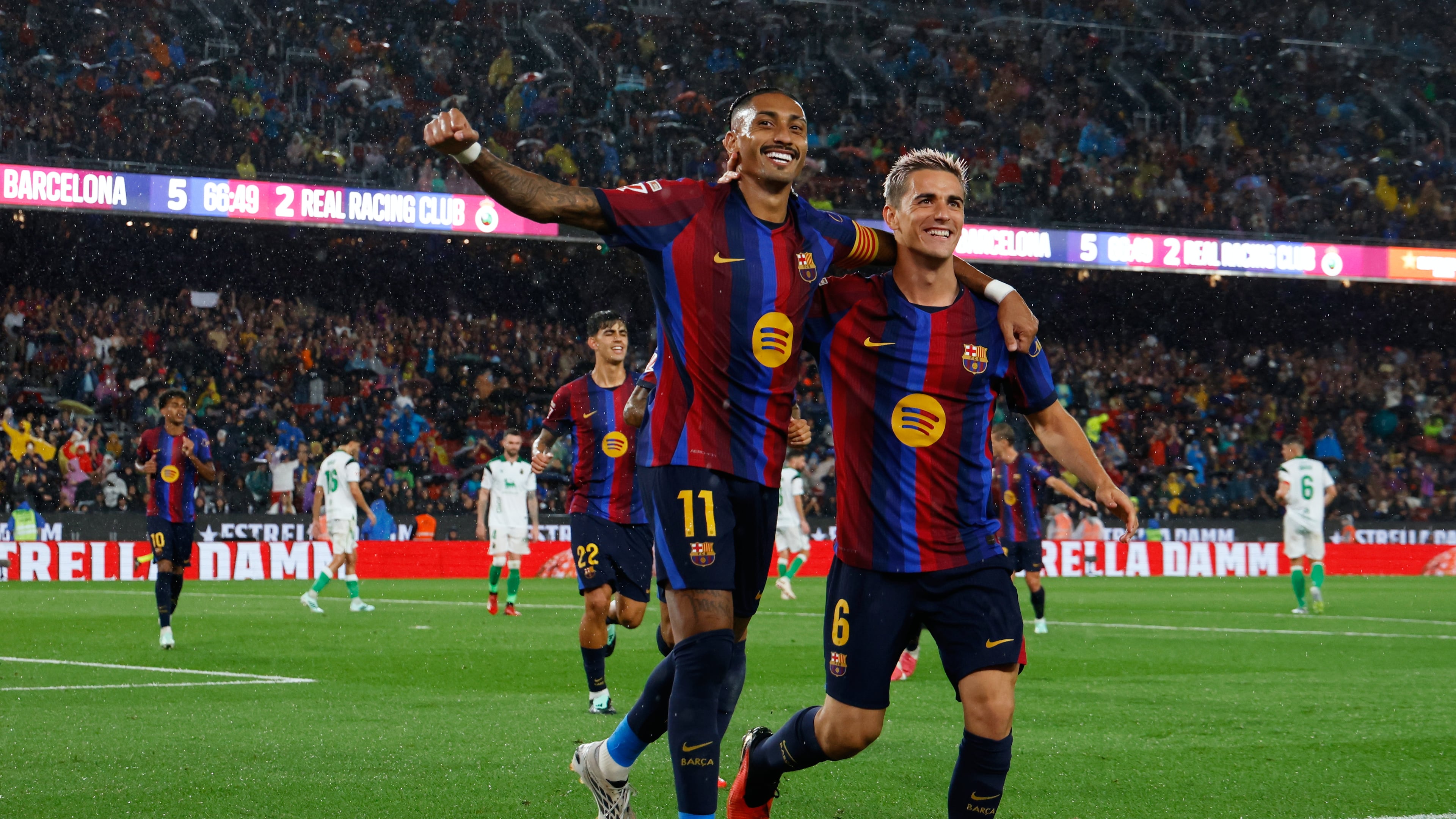 Barcelona's Raphinha celebrates with Gavi, right, after scoring his side's fifth goal from the penalty spot during a Spanish La Liga soccer match between Barcelona and Racing de Santander in Barcelona, Spain, Wednesday, Sept. 16, 2026. (AP Photo/Joan Monfort)