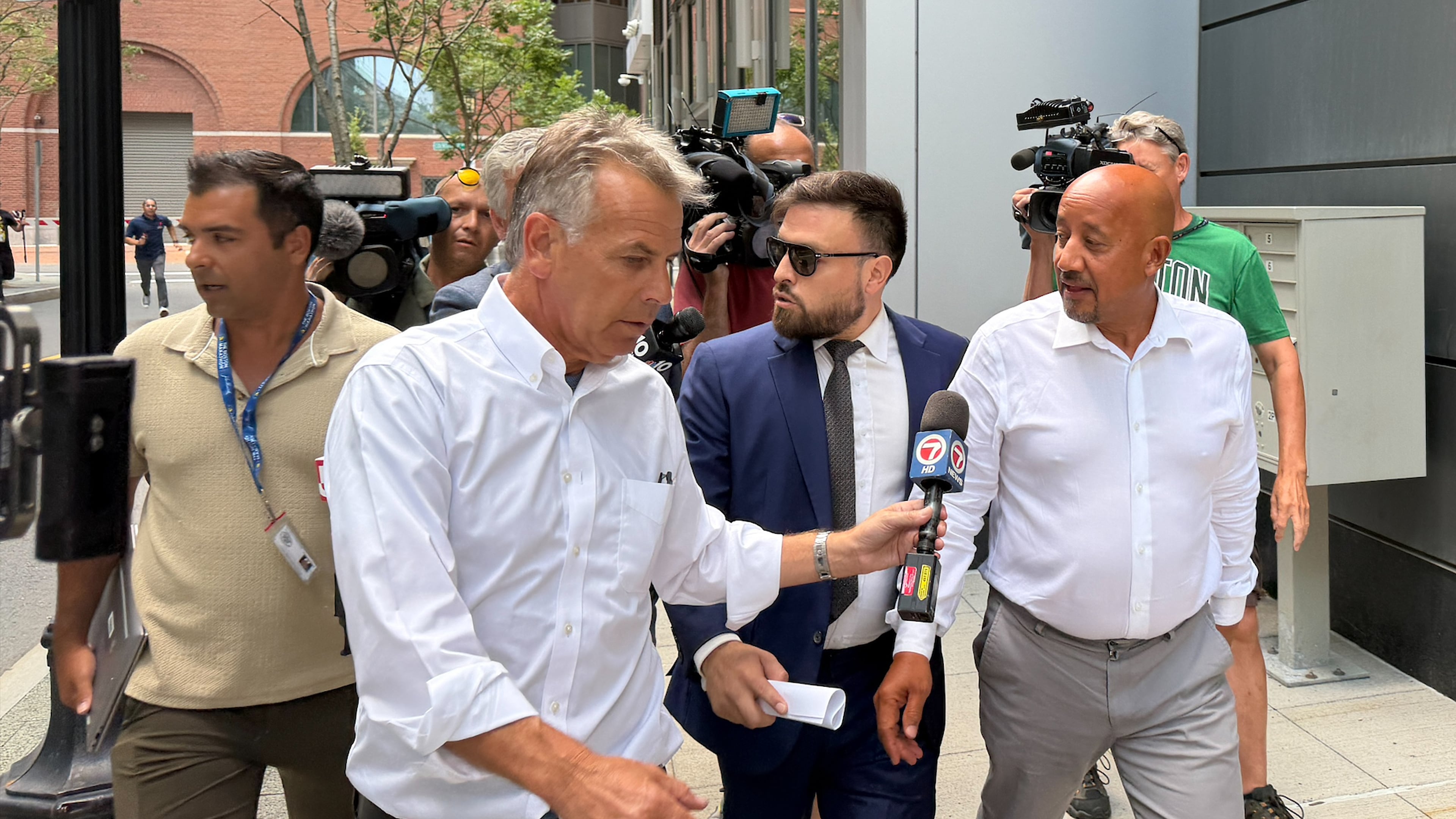 Lawrence, Mass., Mayor Brian DePena, right, leaves federal court in Boston on Friday, Aug. 14, 2026, after making an initial appearance on charges that he fraudulently obtained a pandemic loan and using the money to fund election campaign, pay off high-interest mortgages and back taxes. (AP Photos/Michael Casey)