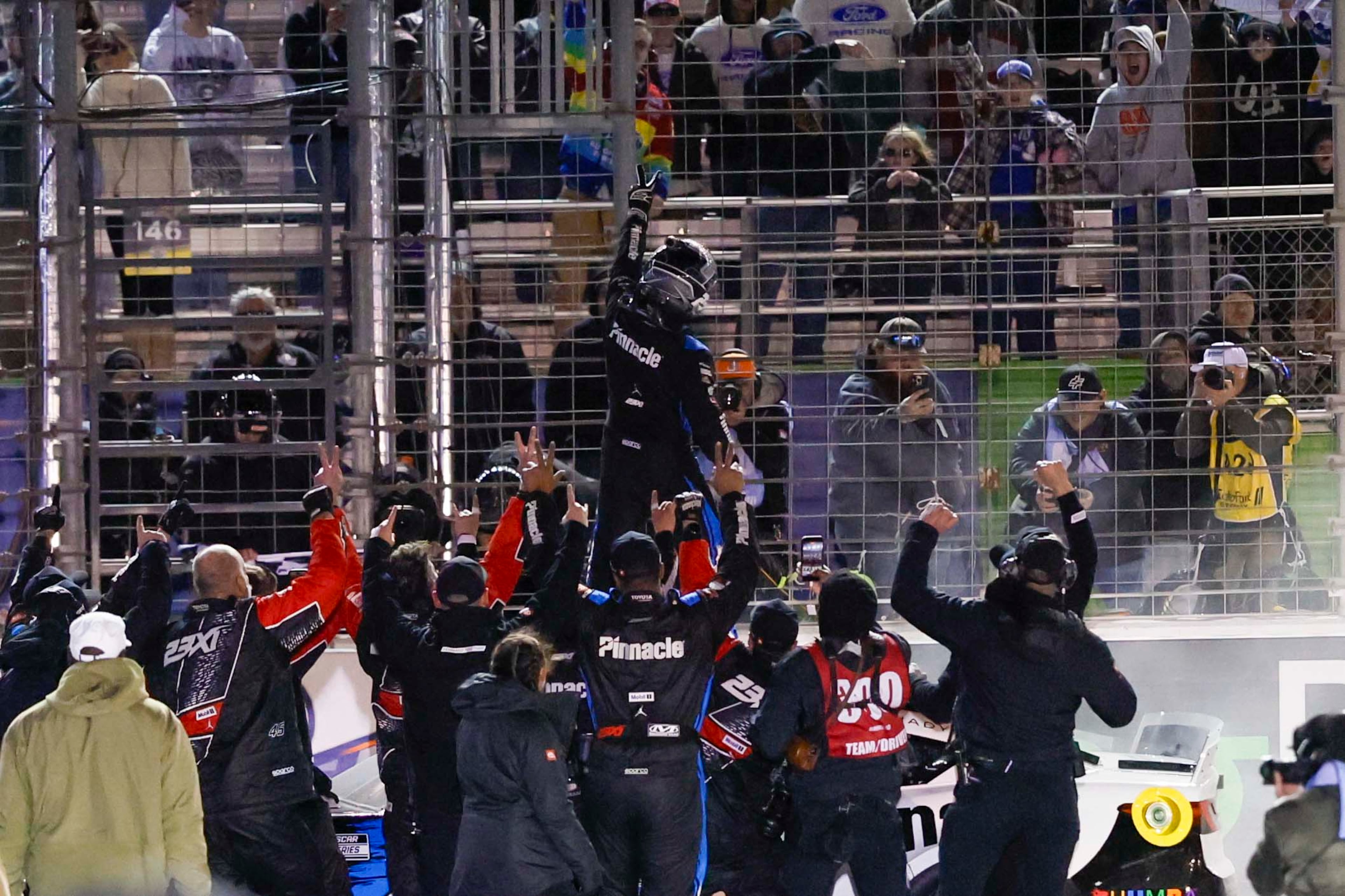 23XI Racing driver Tyler Reddick (45) celebrate with fans after winning the NASCAR Autotrader 400 at EchoPark Speedway on Sunday, Feb. 22, 2026, in Hampton, Ga. This marks Reddick’s second consecutive victory. (Miguel Martinez/AJC)