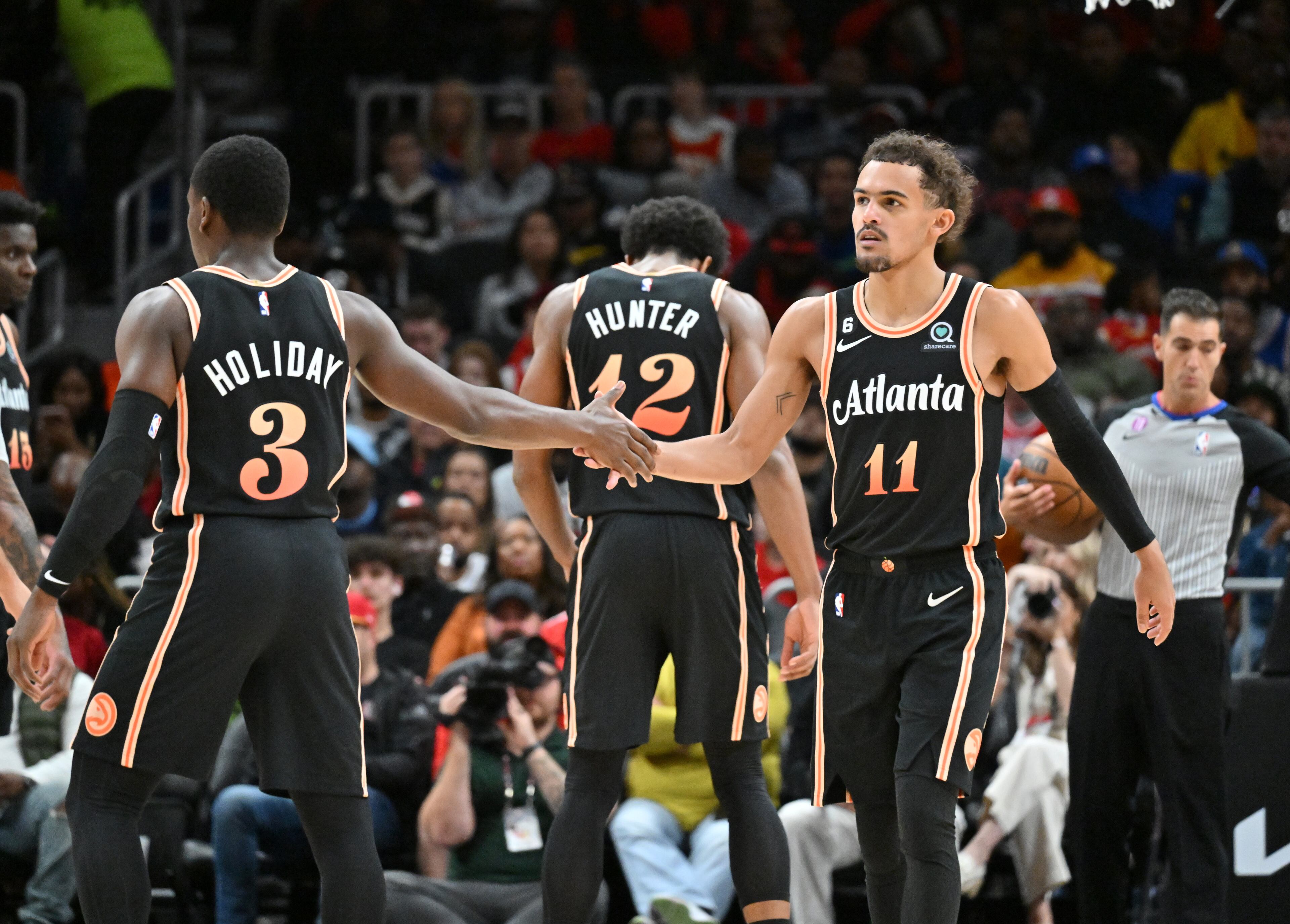 Hawks guards Aaron Holiday (3) and Trae Young (11) celebrate during the second half. (Hyosub Shin / Hyosub.Shin@ajc.com)