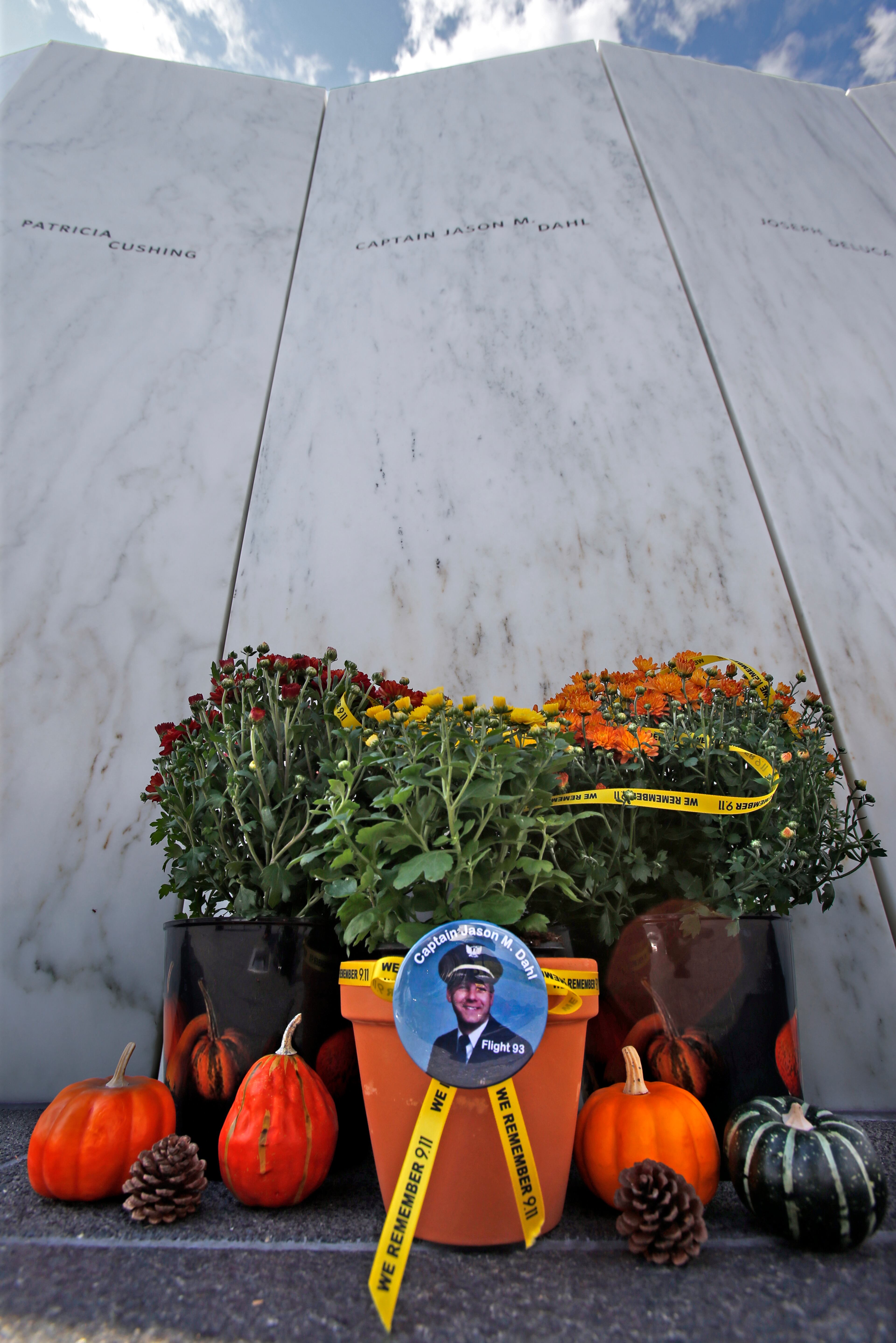 Plants and gourds sit at the base of the Wall of Names in memory of United Flight 93 pilot Captain Jason M.Dahl at the Flight 93 Memorial in Shanksville, Pa, on Wednesday, Sept. 9, 2015. The memorial's new visitors center will be formally dedicated and open to the public on Sept. 10, 2015. (AP Photo/Gene J. Puskar)