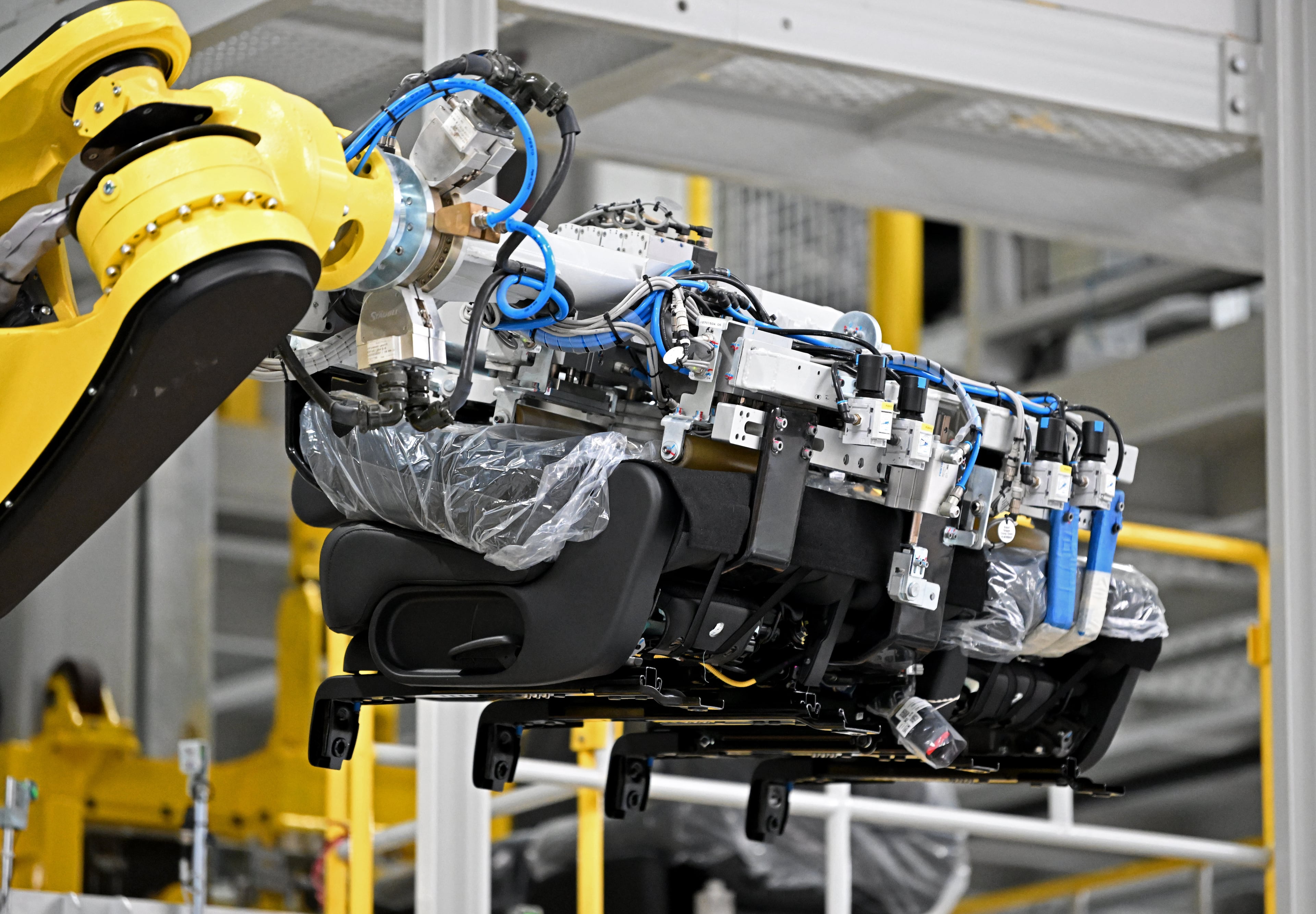 A robot installs a car seat on the assembly line at Hyundai Motor Group Metaplant America (HMGMA) in Ellabell on Wednesday, May 6, 2026. (Hyosub Shin/AJC)