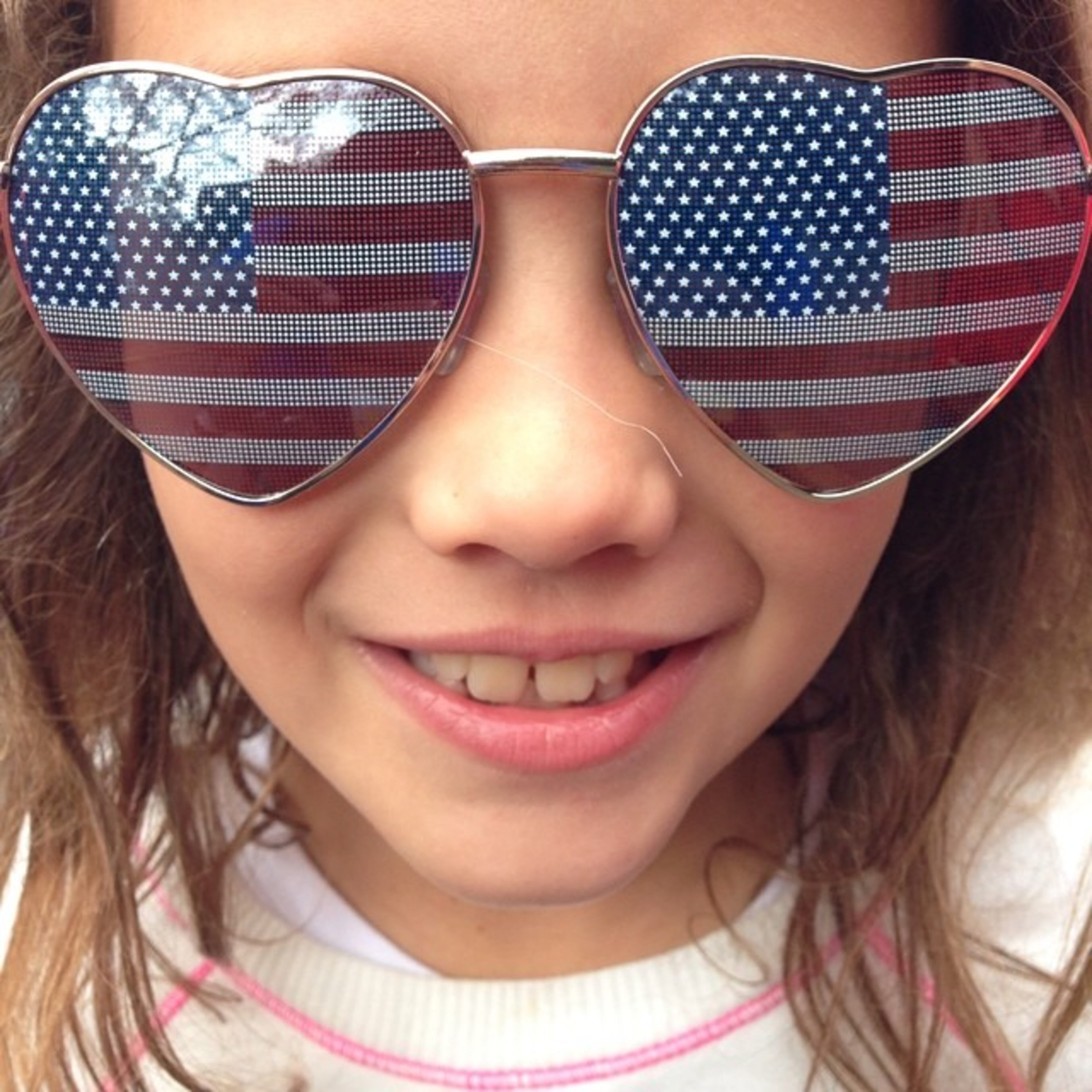 Alinee, 7, of San Diego, shows her love for Team USA in Sao Paulo, Brazil. (AP Photo/Julio Cortez)