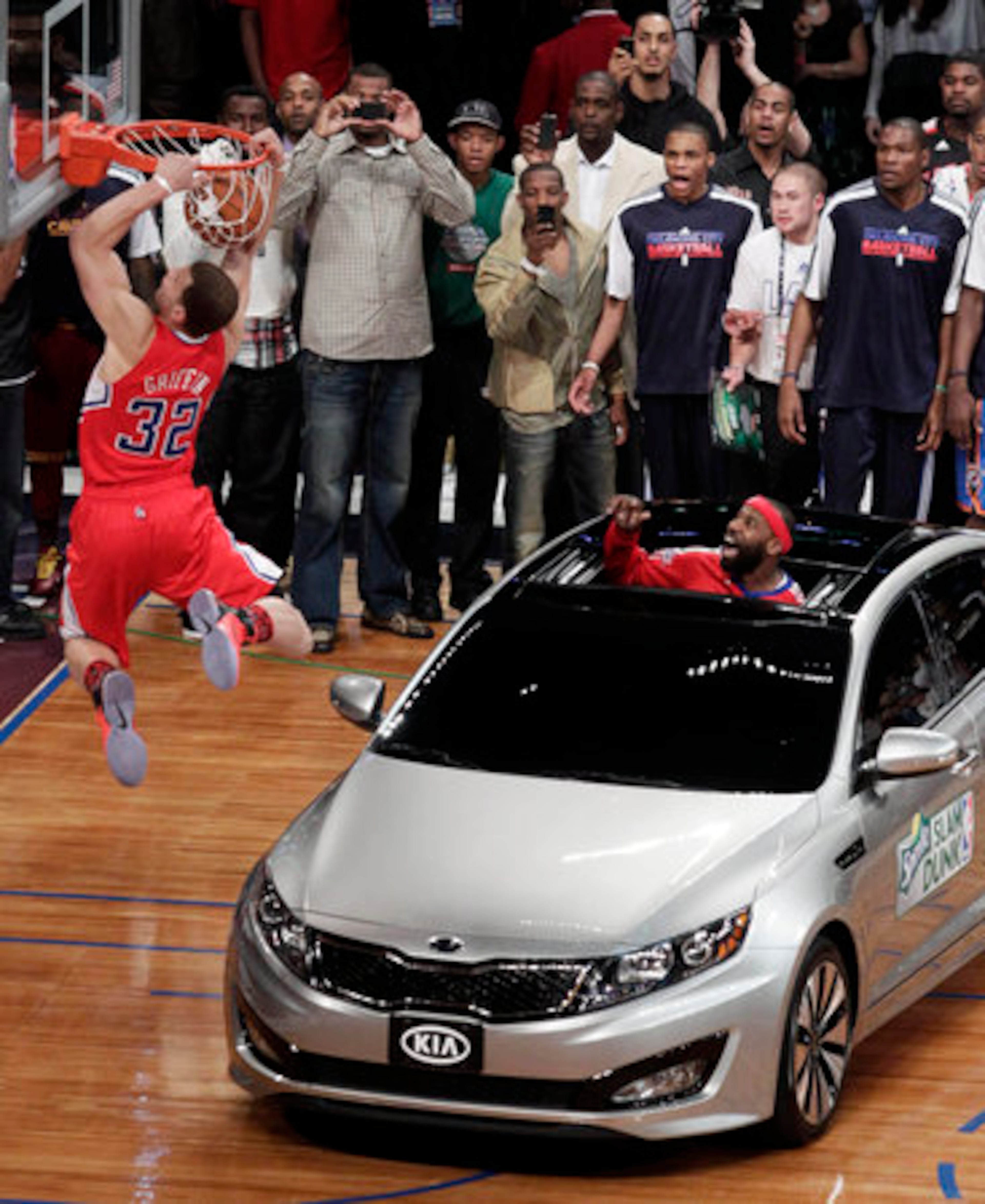 Los Angeles Clippers' Blake Griffin flies over a car for a dunk after teammate Baron Davis threw him the ball from the sunroof during the Slam Dunk Contest at the NBA basketball All-Star Saturday Night, Saturday, Feb. 19, 2011, in Los Angeles.