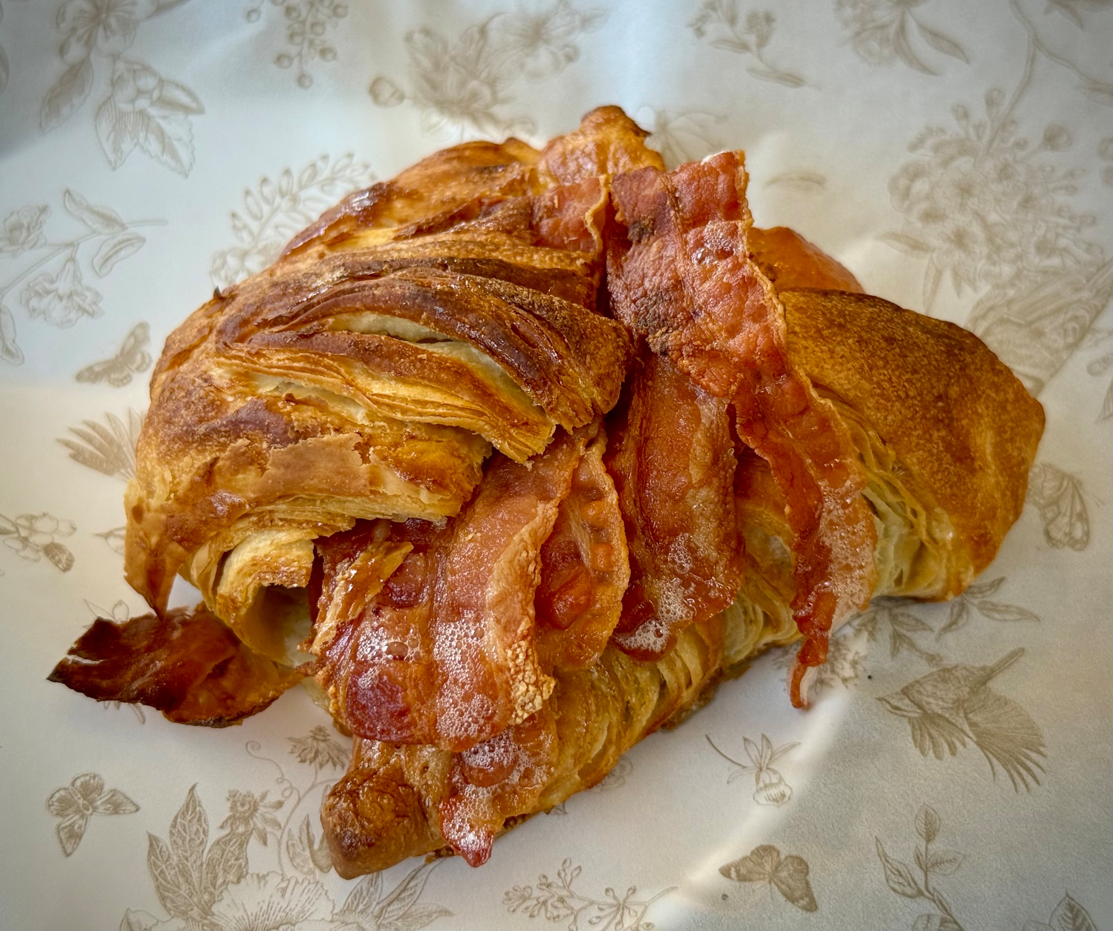 The bacon and egg croissant sandwich at Stellow Coffee & Floral. (Henri Hollis/AJC)