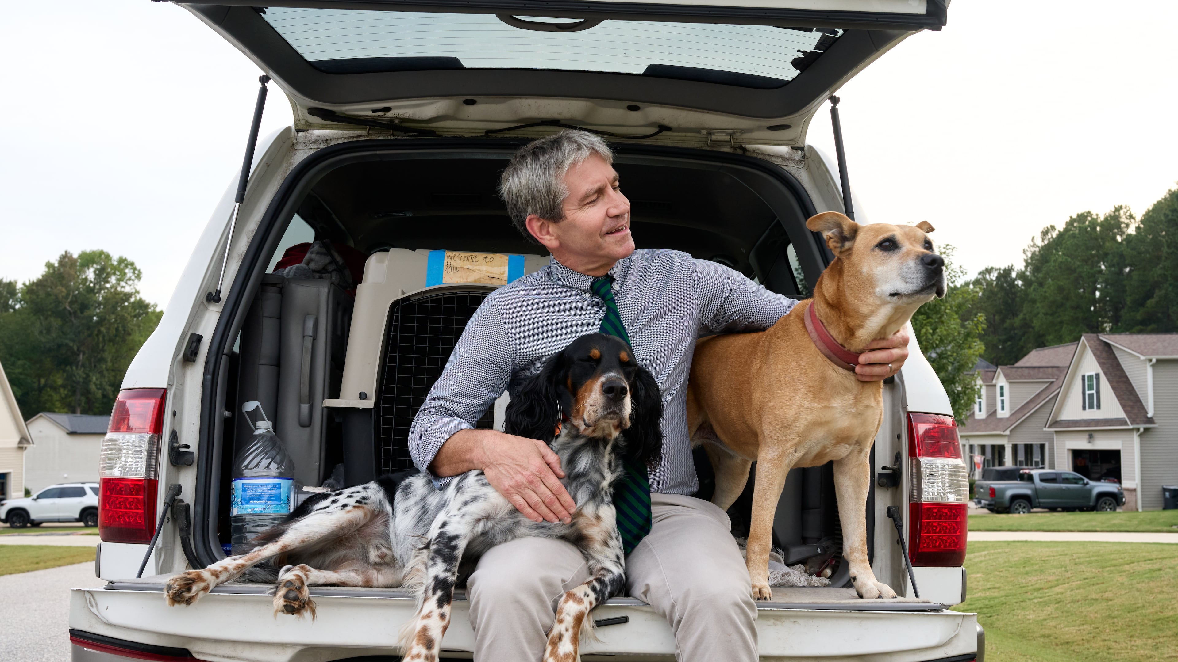 Paul Barringer, the Democratic nominee running for North Carolina's 13th Congressional District, poses for a photo with his dogs, Billie and Penny, on Oct. 8, 2026, in Garner, N.C. (AP Photo/Matt Ramey)