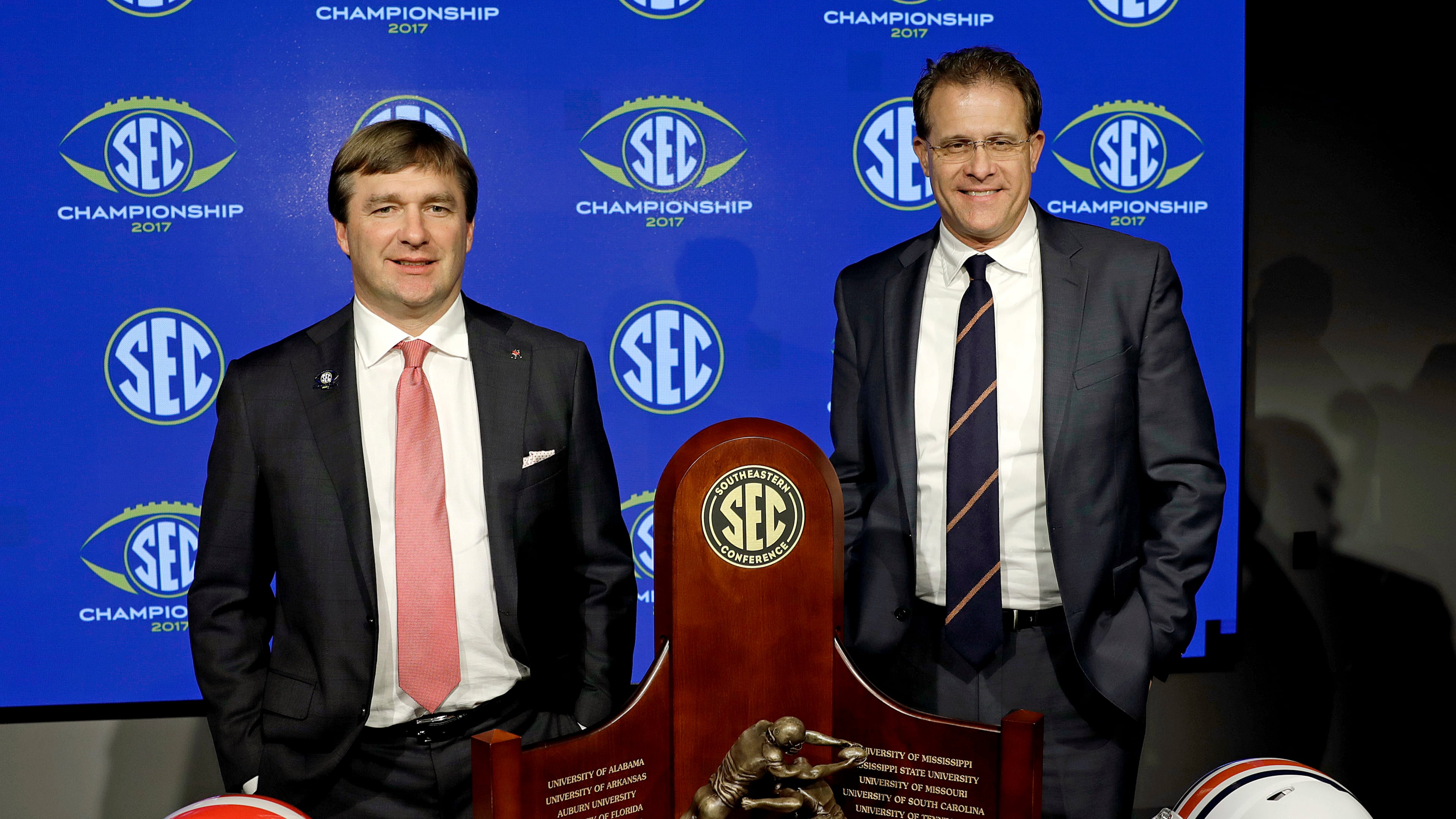 Two men, two helmets, one trophy.
