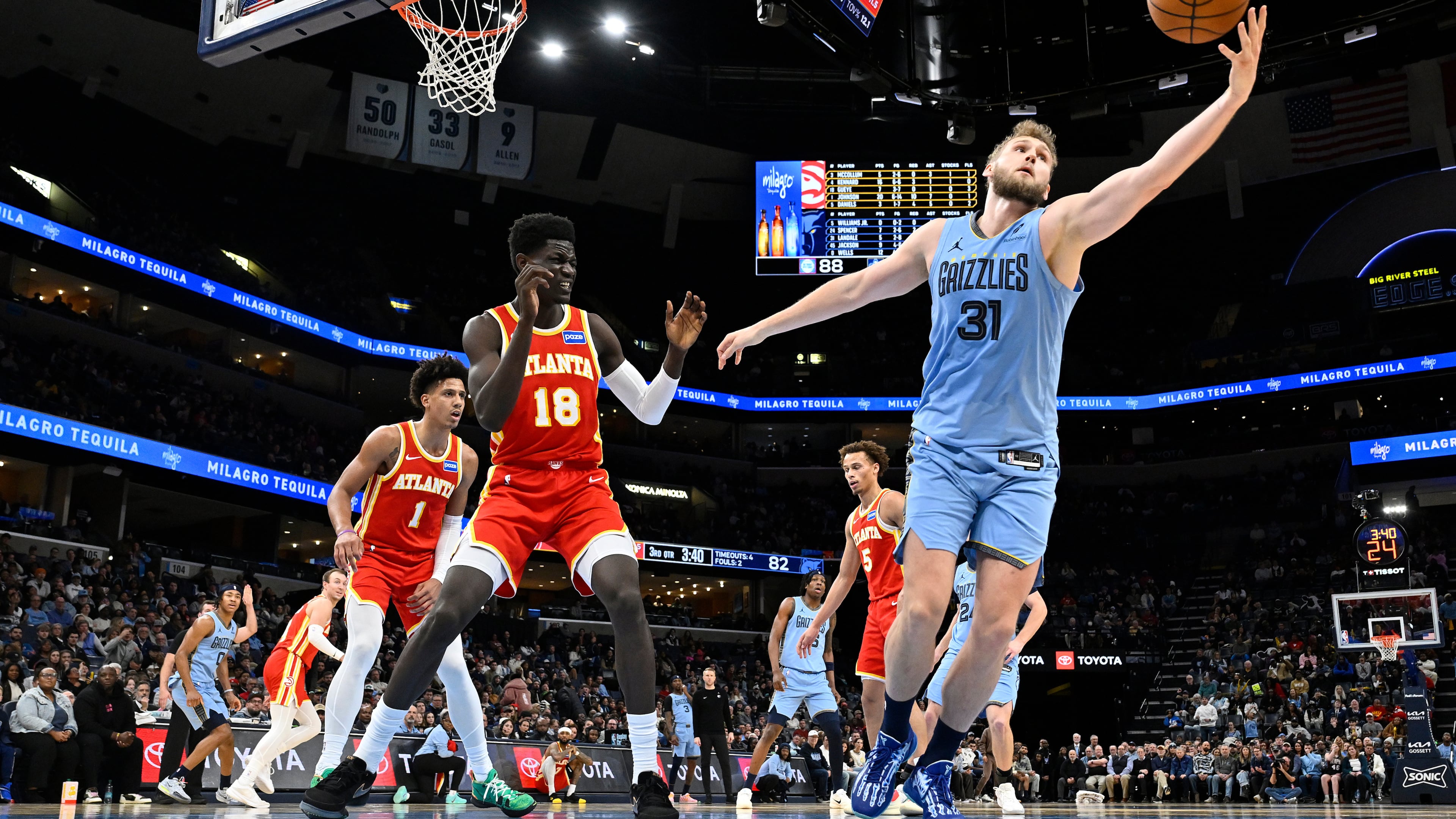 Grizzlies center Jock Landale (right) reaches for the ball ahead of Hawks forward Mouhamed Gueye (center) on Wednesday, Jan. 21, 2026, in Memphis, Tenn. On Wednesday, the Hawks acquired Landale, who is averaging a career-high 11.3 points this season. (Brandon Dill/AP)