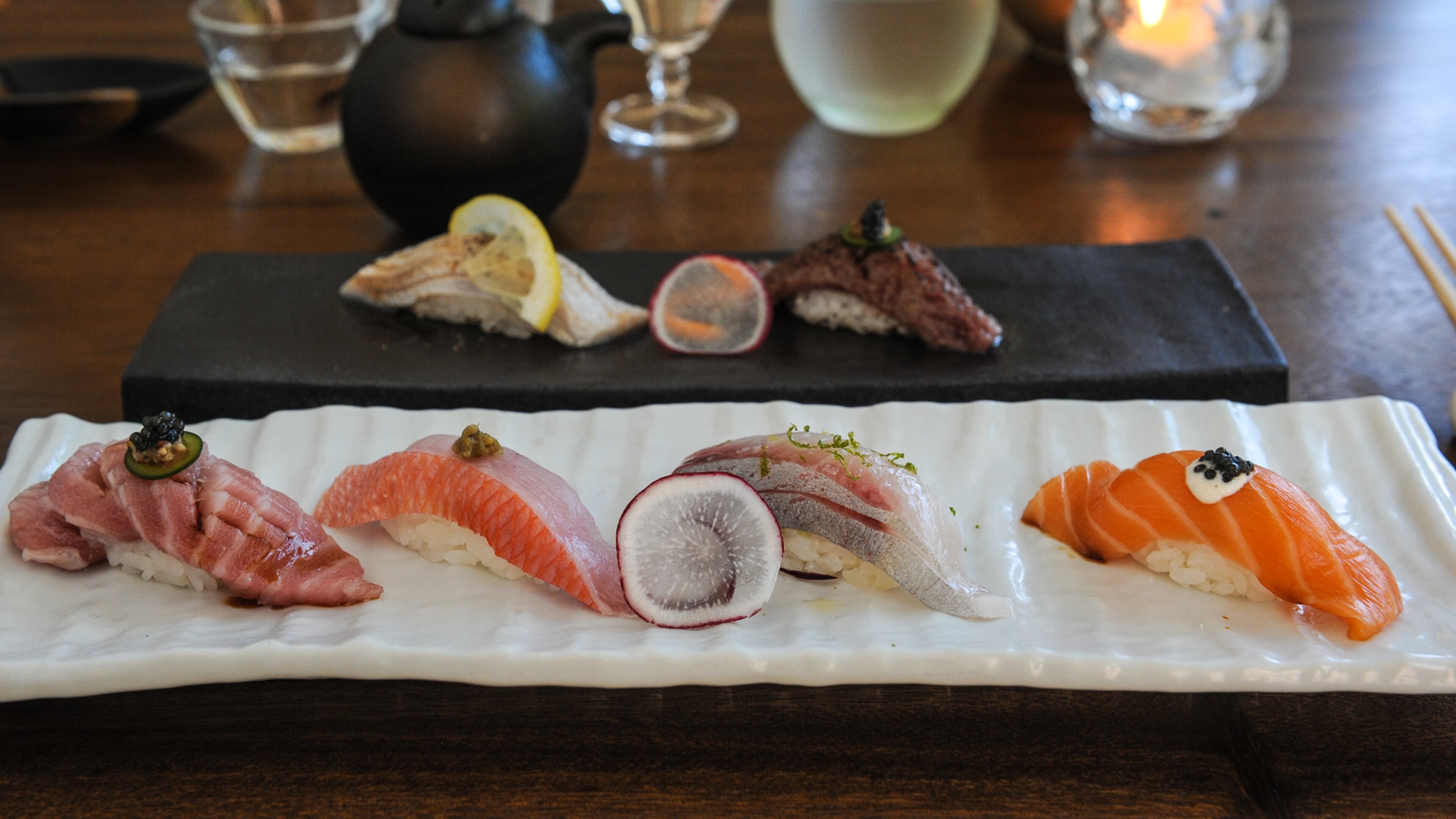 Selection of seared and fresh nigiri including Sake (fresh salmon with aioli sauce, truffle soy, black pepper and caviar), Hamachi, Kampachi, and Shima aji at MF Sushi. (Becky Stein Photography)