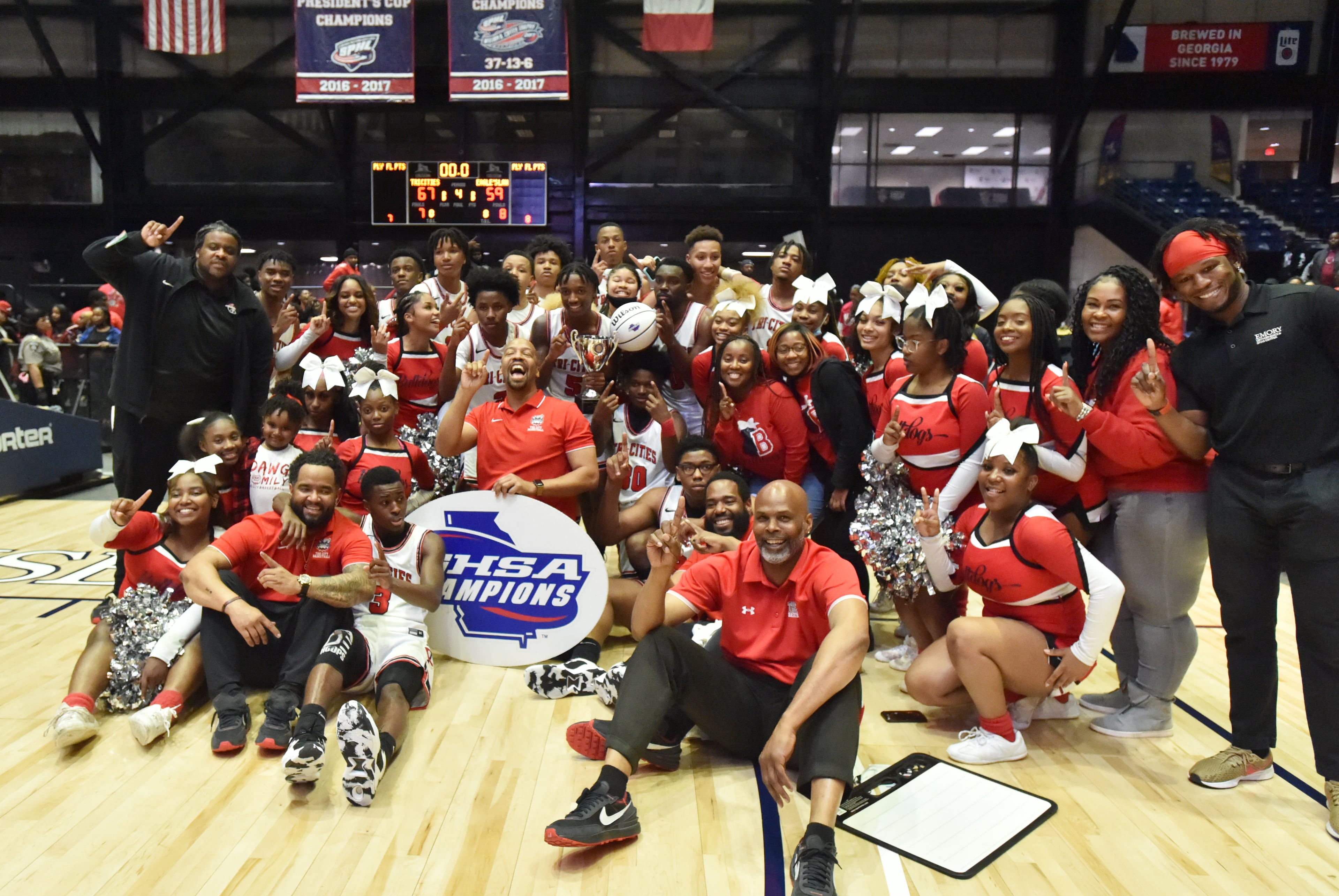 Tri-Cities players and coaching staff pose with cheerleaders after they beat Eagle's Landing. (Hyosub Shin / Hyosub.Shin@ajc.com)