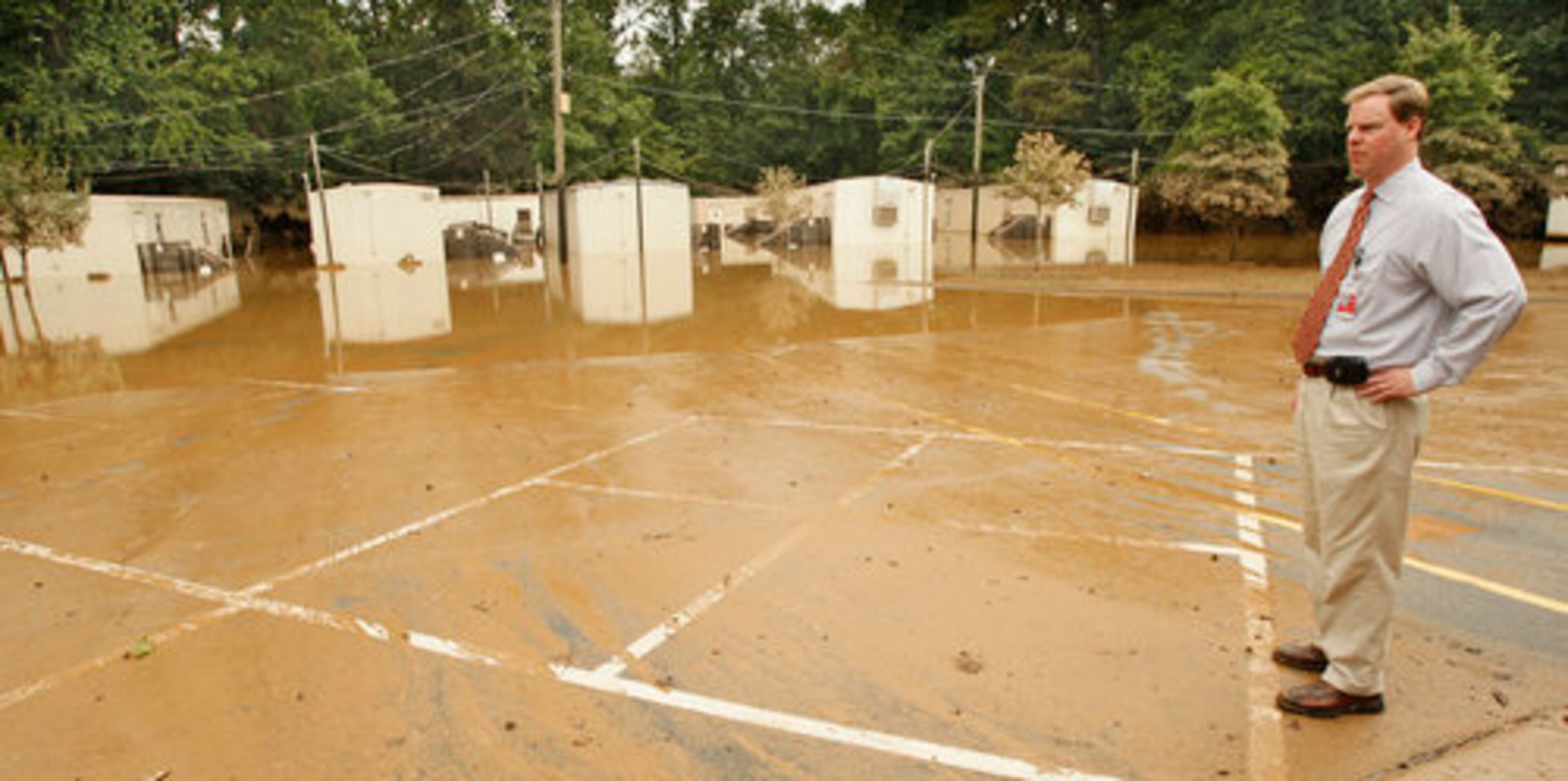 Director of communications Jay Dillon (looking over some of the flooded classroom trailers at Clarkdale Elementary in Austell in 2009) says he is ready to try something new. His last day is December 31.