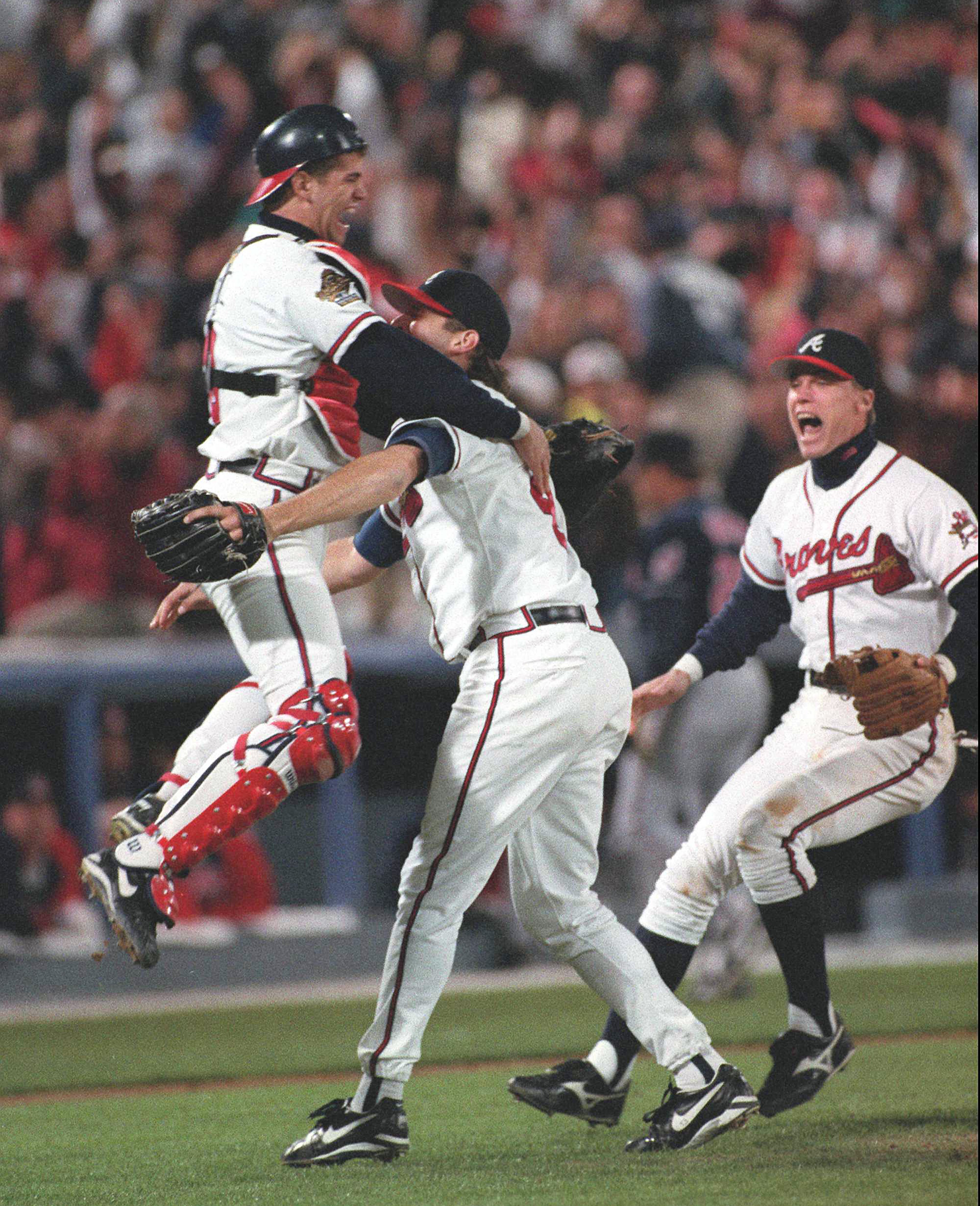 OCTOBER 28, 1995 ATLANTA Javier Lopez leaps into the arms of Mark Wohlers after the last out of the 1995 World Series, Saturday, October 28, 1995. Chipper Jones is at right. (AJC photo/Frank Niemeir)