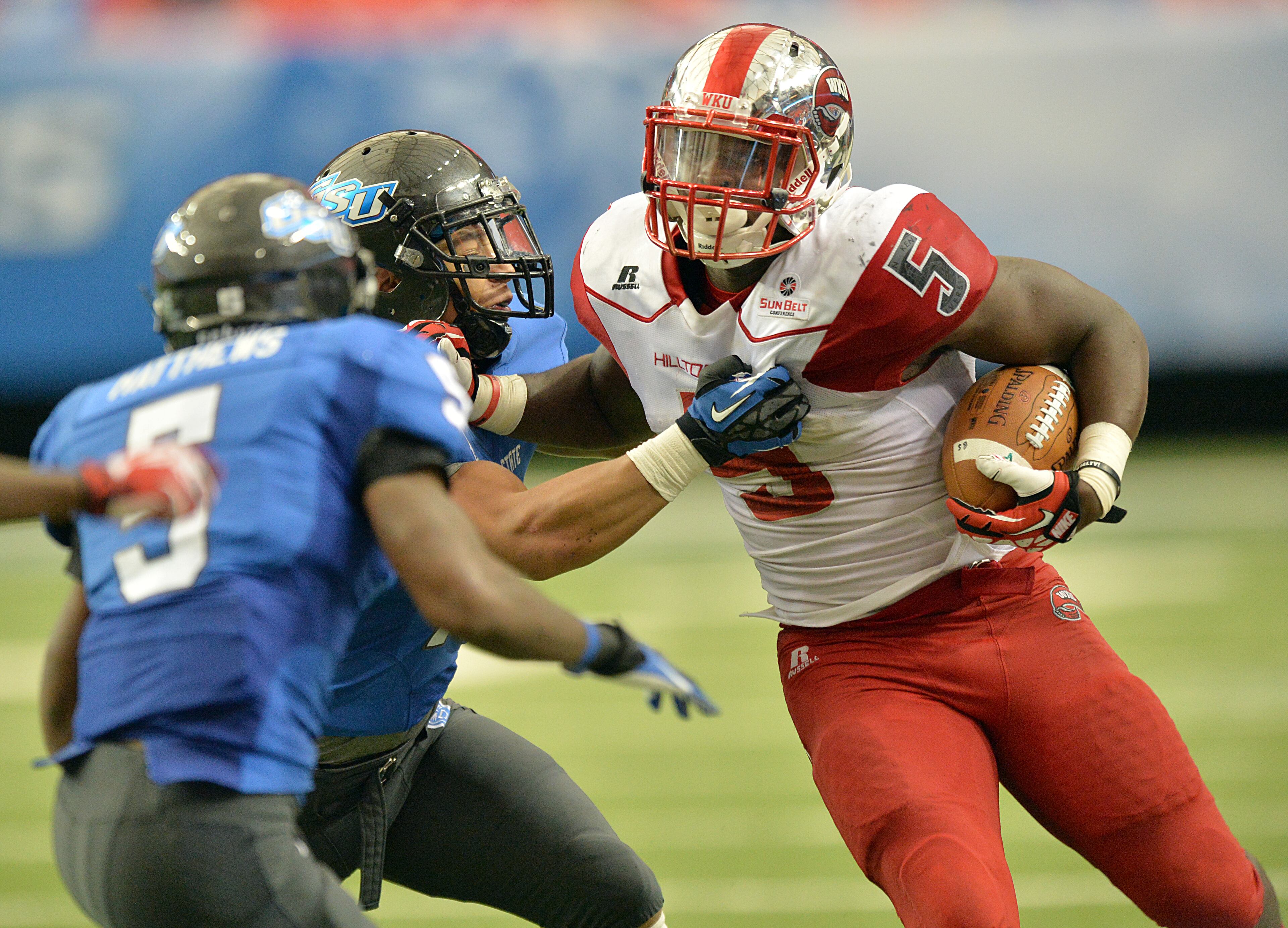 Western Kentucky Hilltoppers running back Antonio Andrews (5) is stopped by Georgia State Panthers safety Arington Jordan (12) in the second half at the Georgia Dome on Saturday, November 2, 2013.
