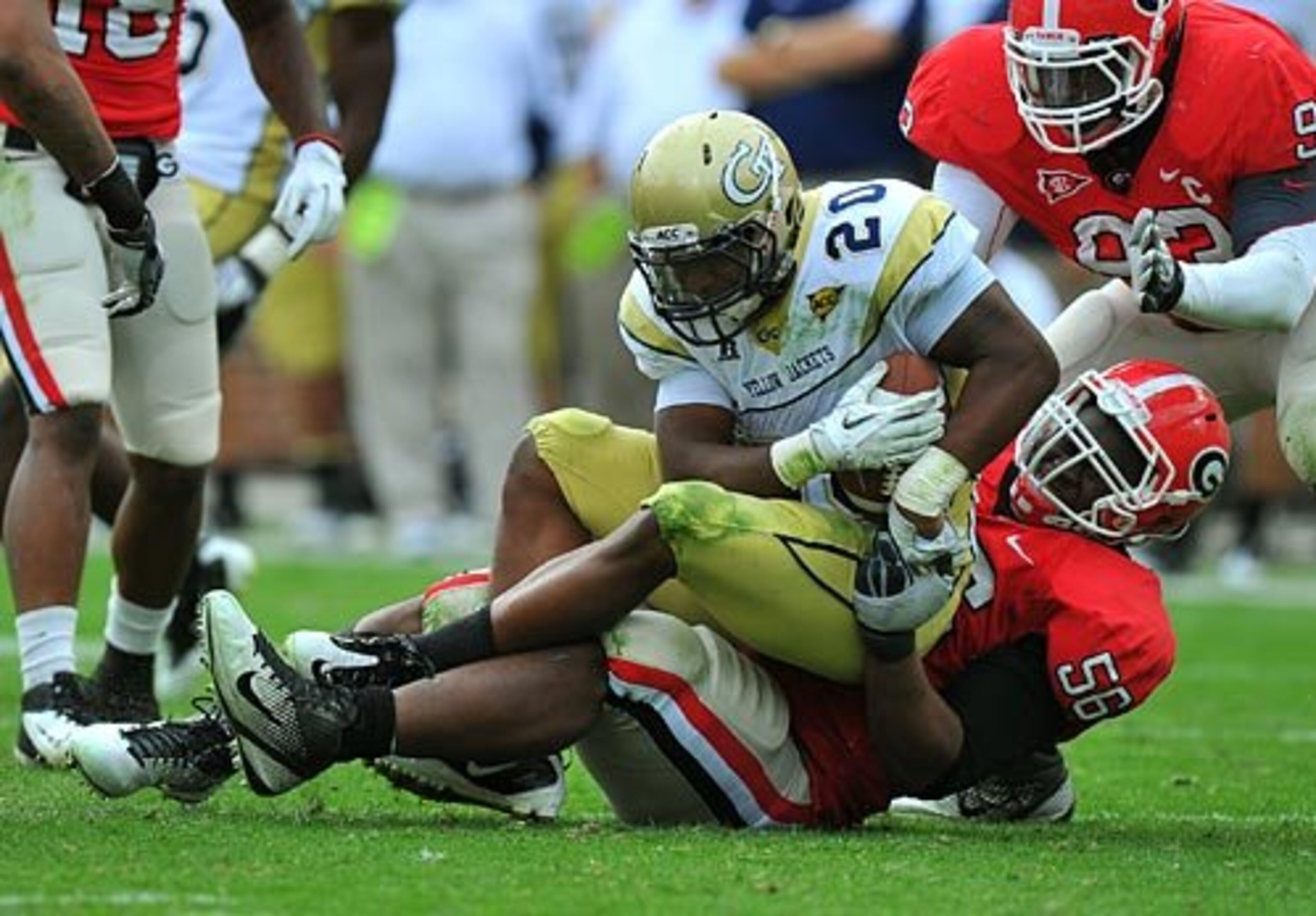 UGA's Garrison Smith (right) brings down Tech RB Roddy Jones (20).