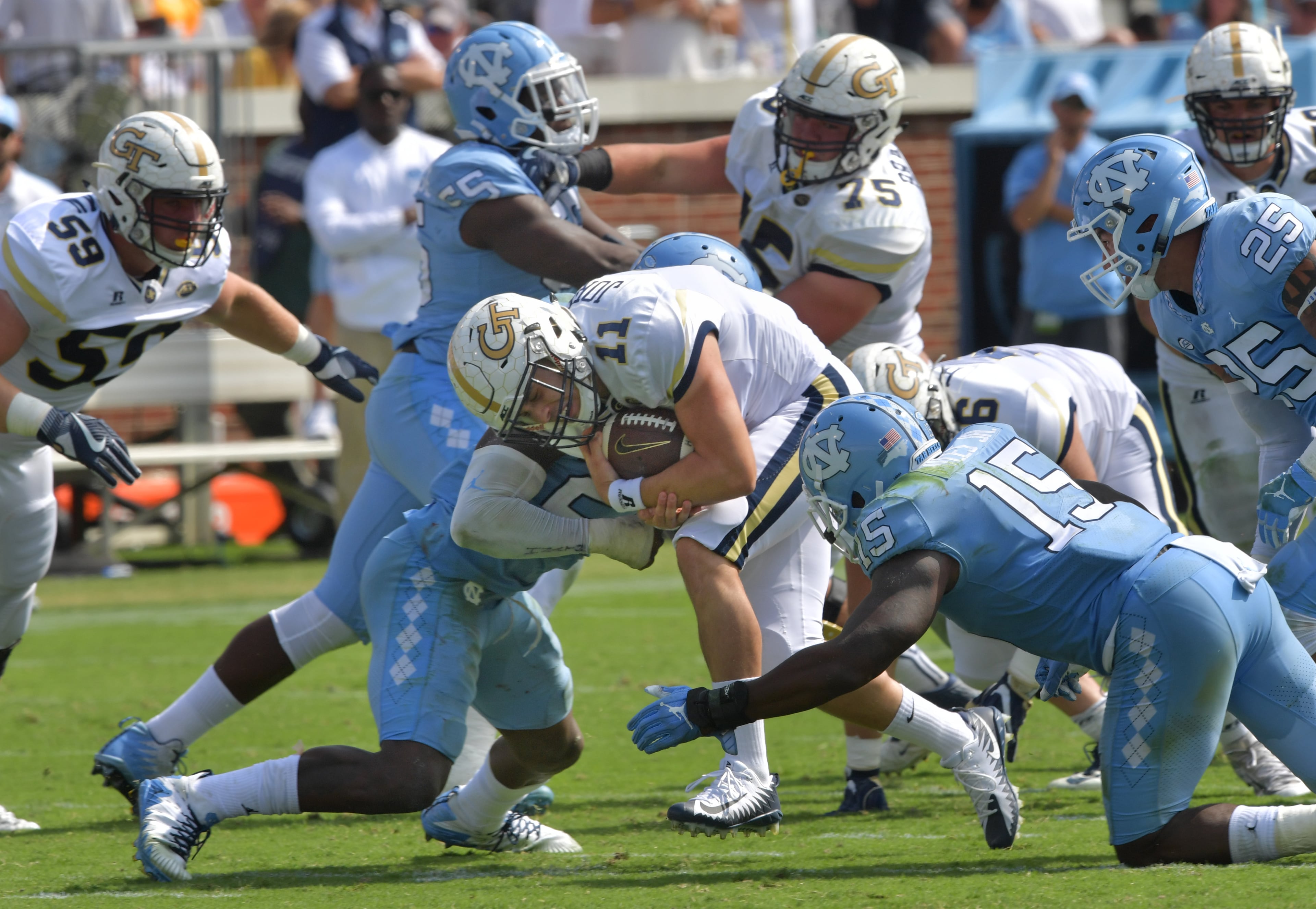 September 30, 2017 Atlanta - Georgia Tech quarterback Matthew Jordan (11) is stoped by North Carolina linebacker Cayson Collins (23) in the second half of an NCAA college football game at Bobby Dodd Stadium on Saturday, September 30, 2017. Georgia Tech won 33 - 7 over the North Carolina. HYOSUB SHIN / HSHIN@AJC.COM