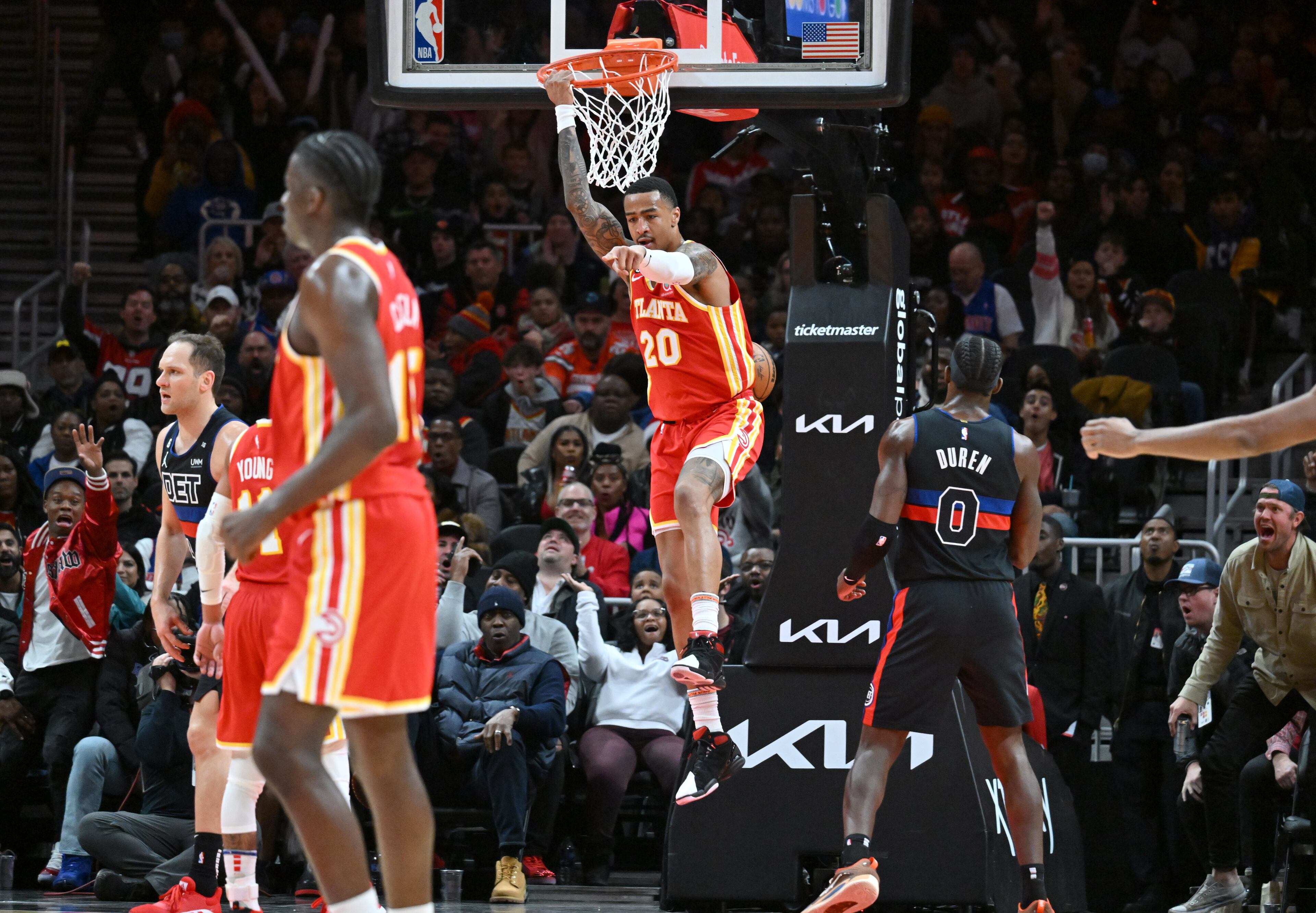 December 23, 2022 Atlanta - Atlanta Hawks' forward John Collins (20) hangs on the basket after dunking the ball during the second half in an NBA basketball game at State Farm Arena on Friday, December 23, 2022. Atlanta Hawks won 130-105 over Detroit Pistons. (Hyosub Shin / Hyosub.Shin@ajc.com)