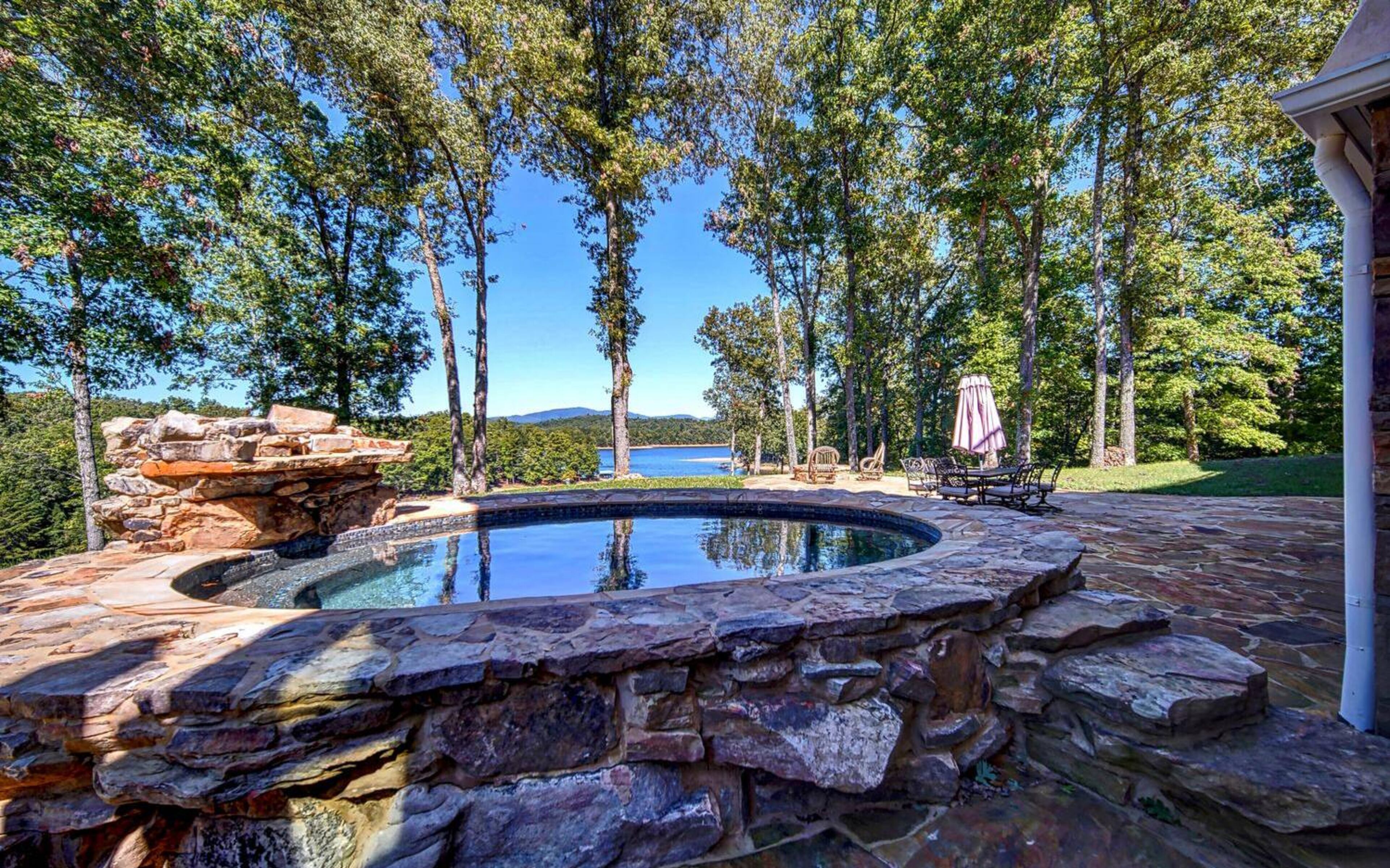 Custom hot tub overlooking beautiful lake and mountain views.