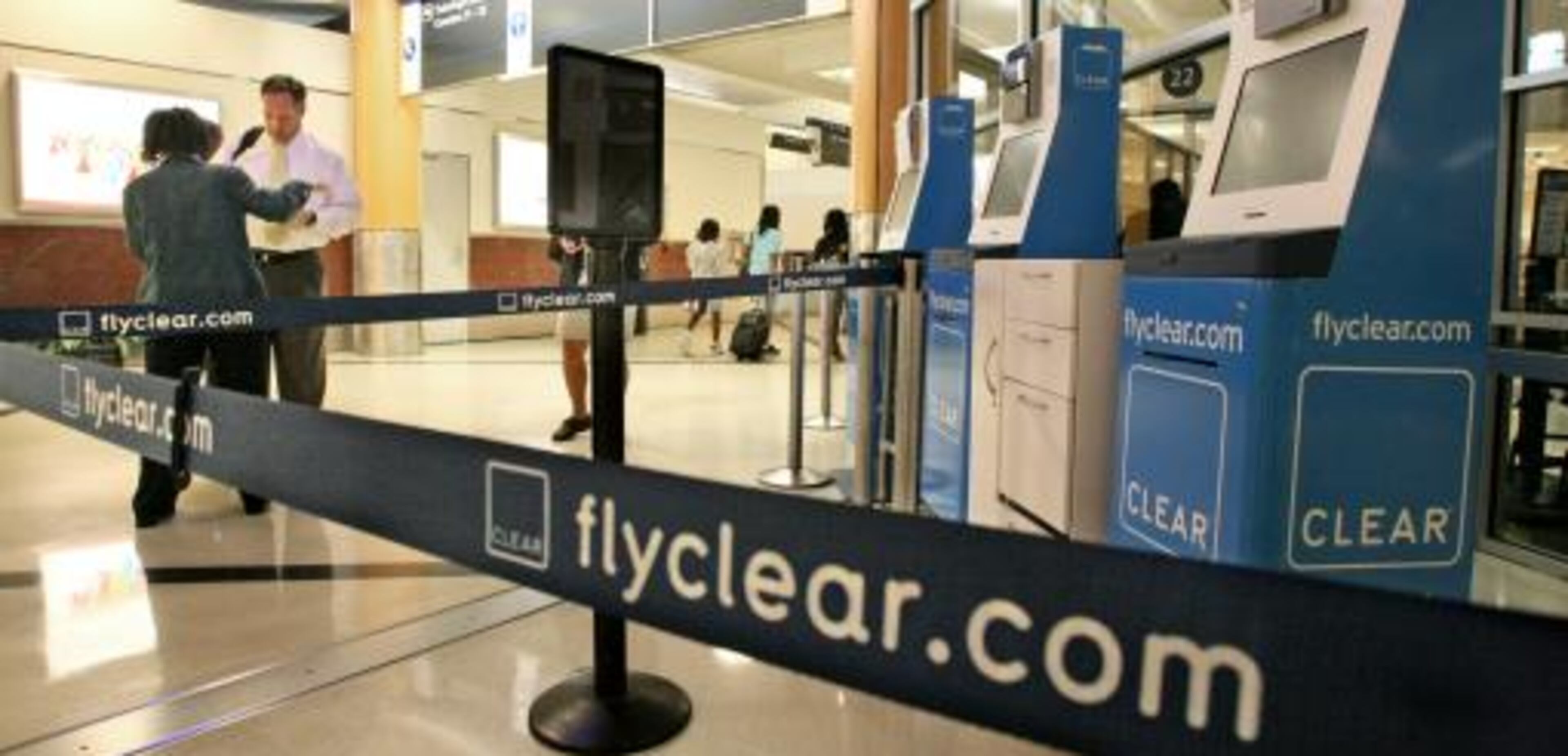 090623 - Atlanta - AETC Customer Service representative, Valerie Esprit (left) talks with first-time Clear user, Kevin Malone from Atlanta who was heading out on a flight to Dallas Texas Tuesday, June 23, 2009 at Hartsfield-Jackson International Airport in Atlanta, Georgia was not able to use the service because Clear, the company with paid security lines at Hartsfield-Jackson International Airport, is shutting down after failing to reach an agreement with a key creditor, according to its Web site and customer service line. "It's my first time, I was looking forward to it" Malone said before being turned away. The station was roped off and kiosks blocked the entry way where a representative steered customers to other security lines. Clear members paid as much as $199 for an annual membership and underwent background checks to access special security lanes at participating airports around the country. The company targeted frequent business travelers seeking a faster security screening process. John Spink/jspink@ajc.com
